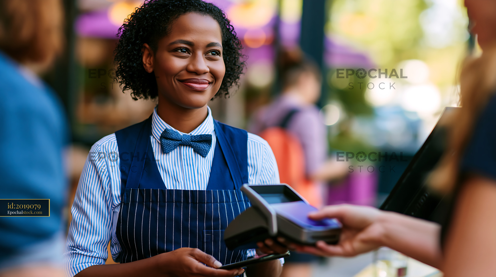 Watermarked full-resolution preview of Customer pays at the cafe with a friendly staff member assisting