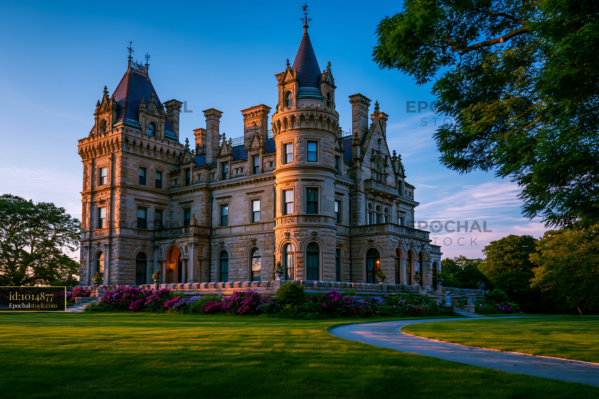 Watermarked full-resolution preview of Historic mansion surrounded by greenery and flowers at sunset
