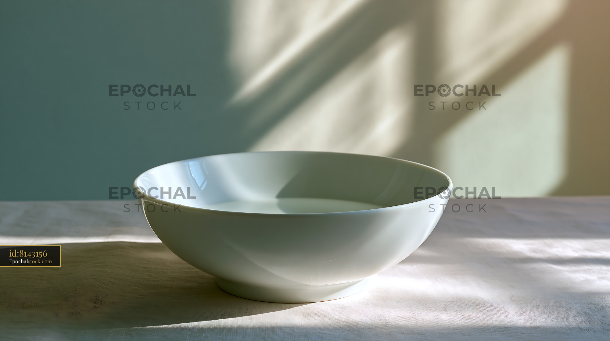 Watermarked full-resolution preview of White ceramic bowl with natural window shadows