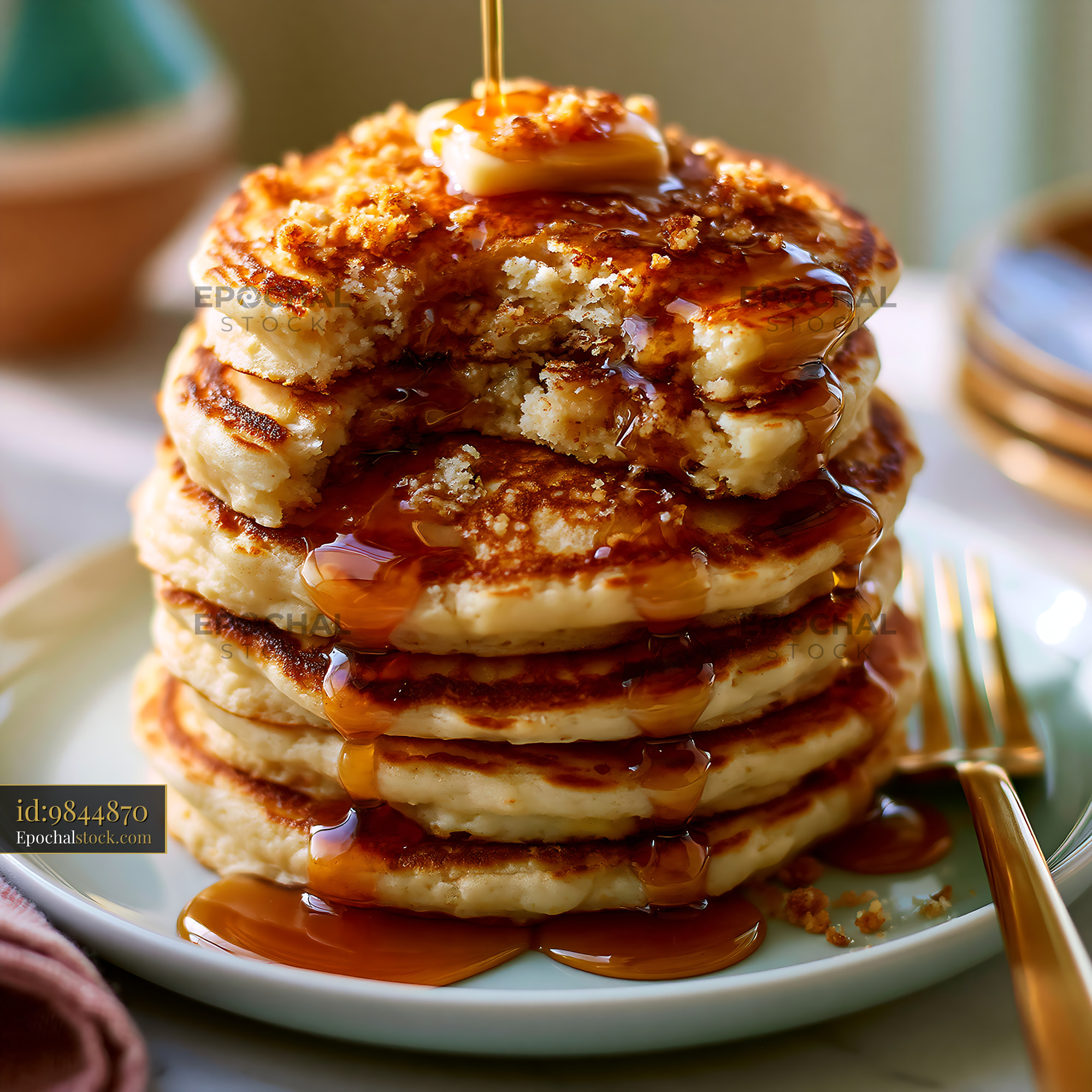 Watermarked full-resolution preview of Stack of pancakes with syrup and butter on a white plate