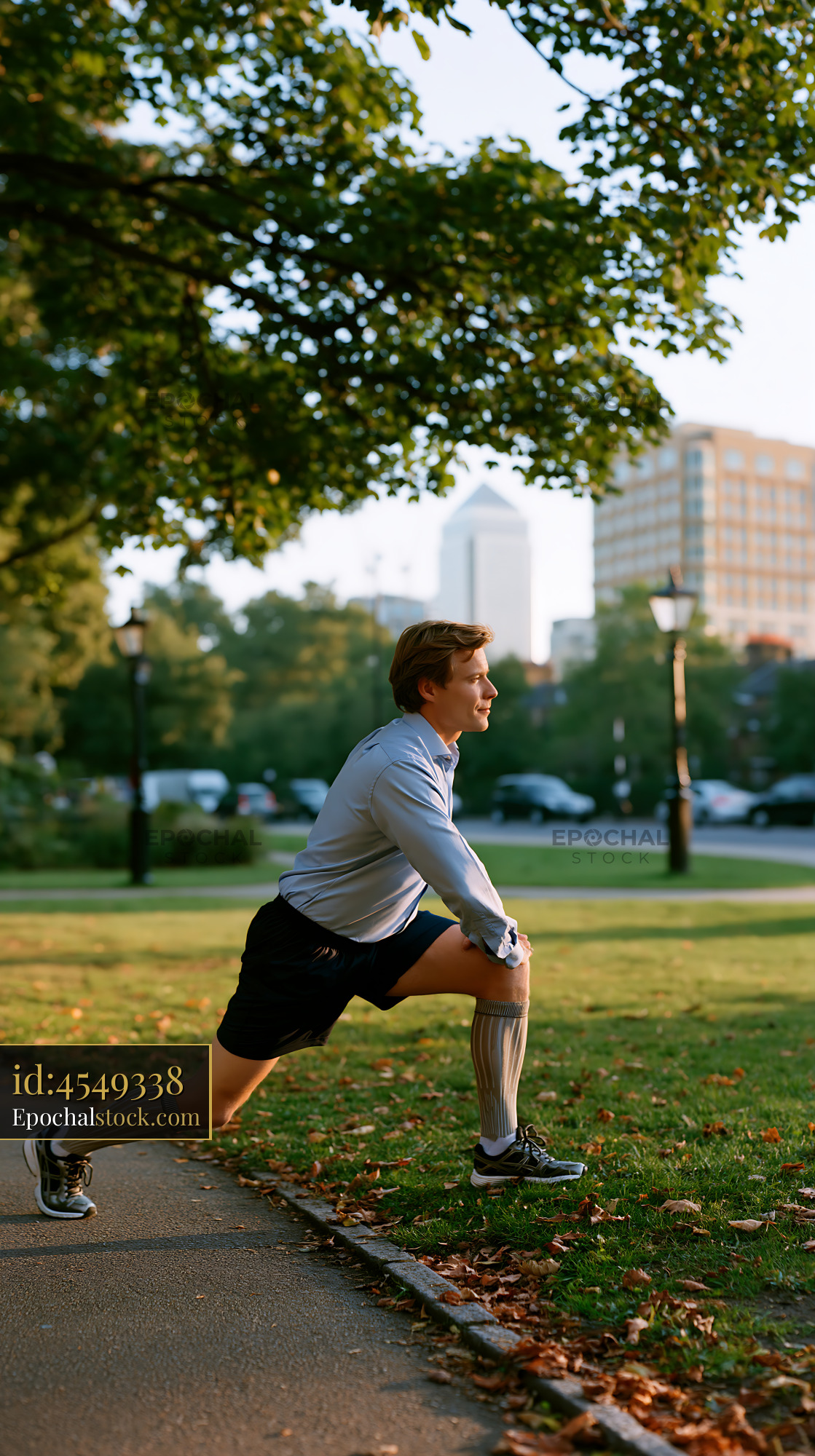 Watermarked full-resolution preview of Man stretching in park during daytime