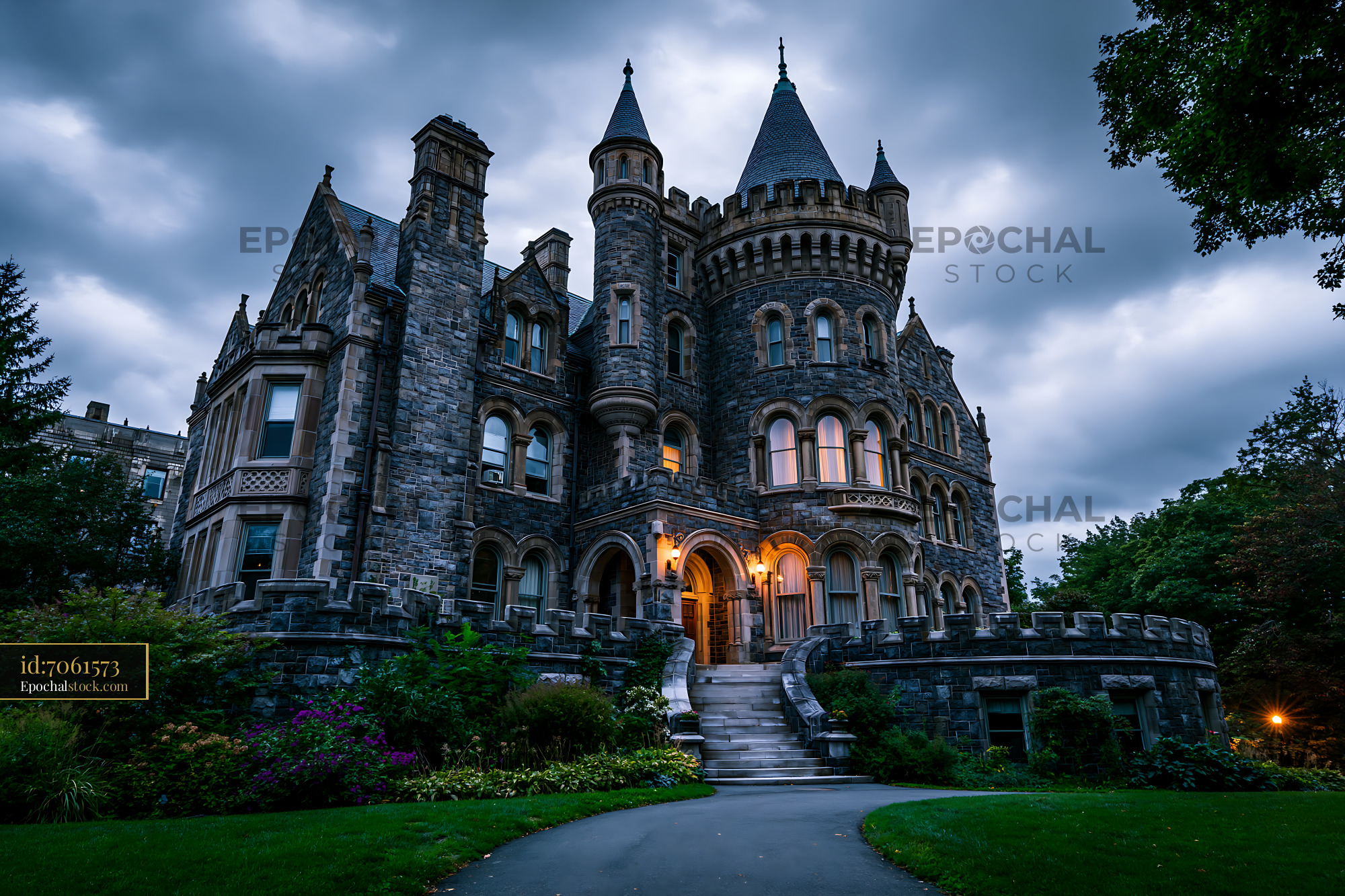 Gothic stone mansion under a dramatic evening sky
