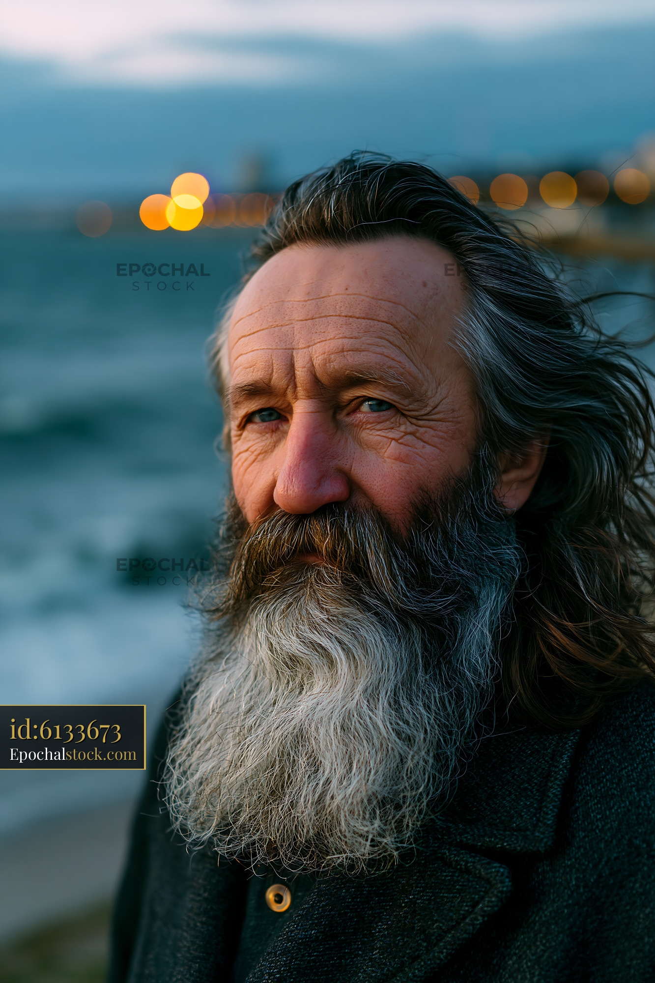 Watermarked full-resolution preview of Man with long beard by the sea at dusk