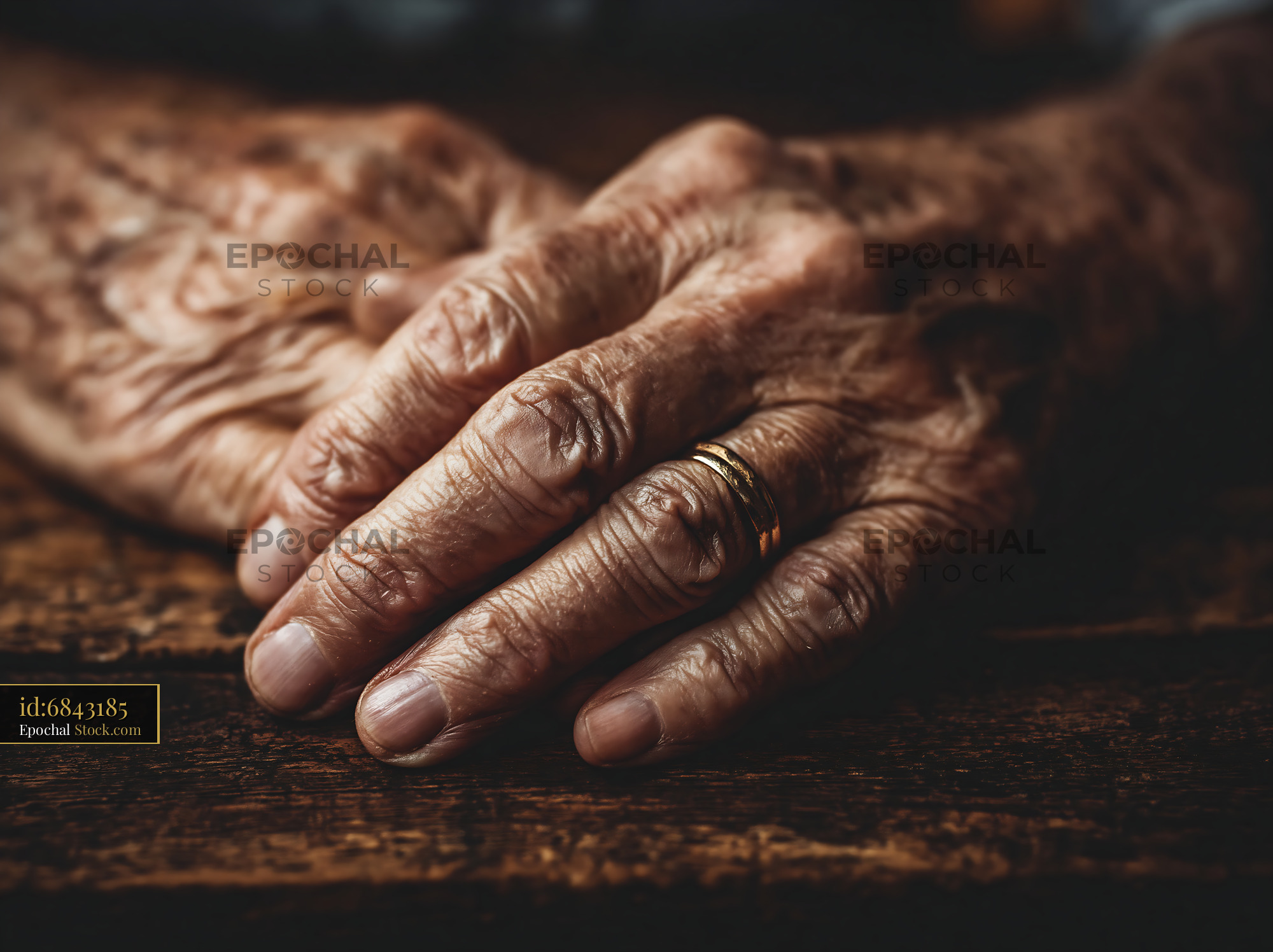 Close-up of wrinkled elderly hands with gold wedding ring - stock photo