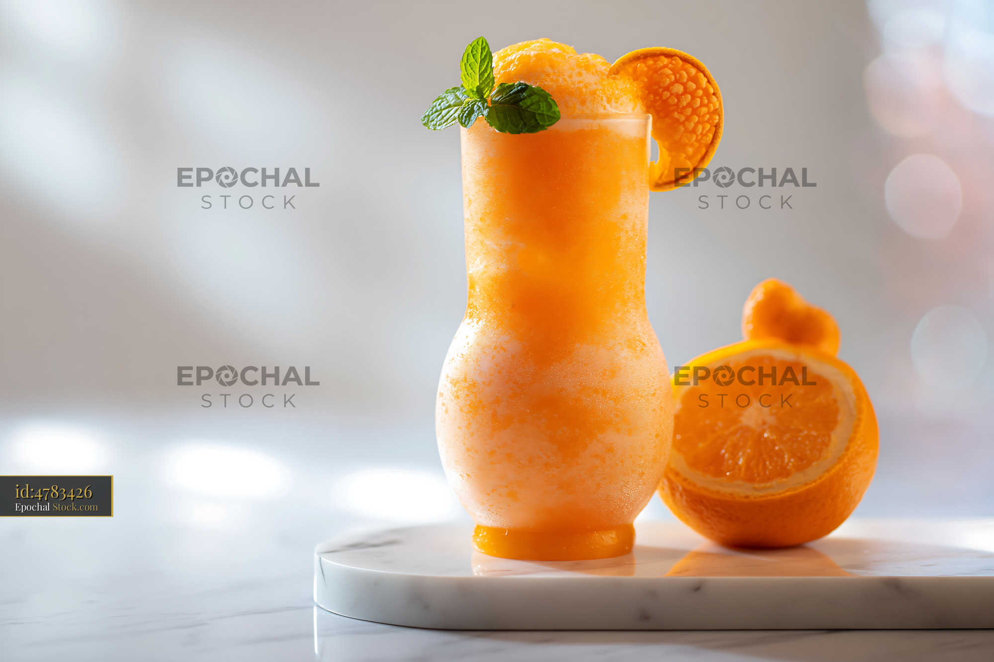 Hallabong citrus smoothie in a glass with fresh mint garnish - stock photo