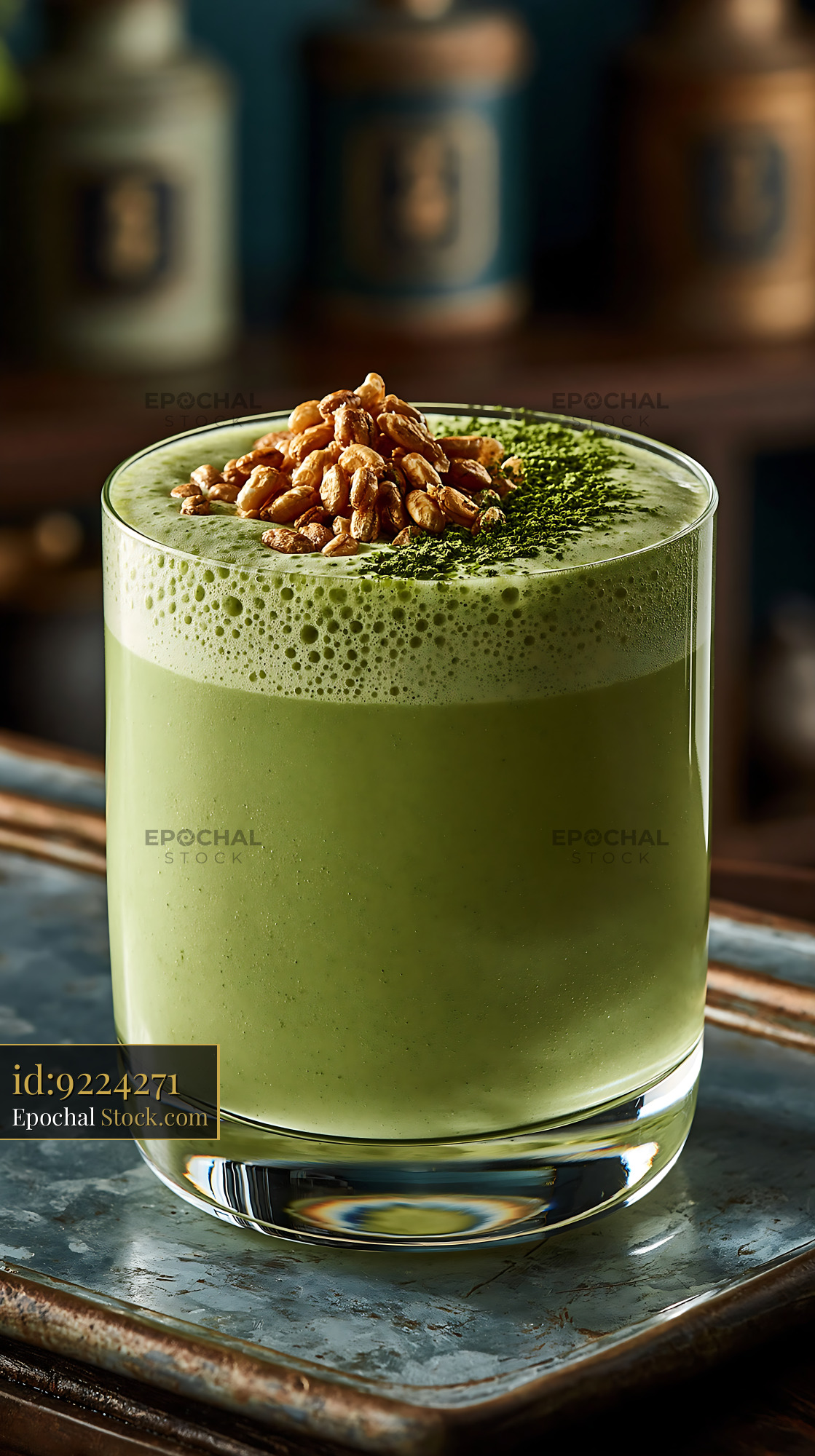 Green kurogoma smoothie with puffed rice topping in a glass - stock photo