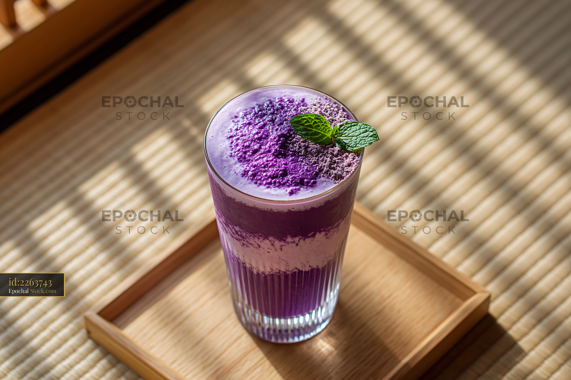 Beni imo smoothie with mint on a wooden tray in morning light - stock photo