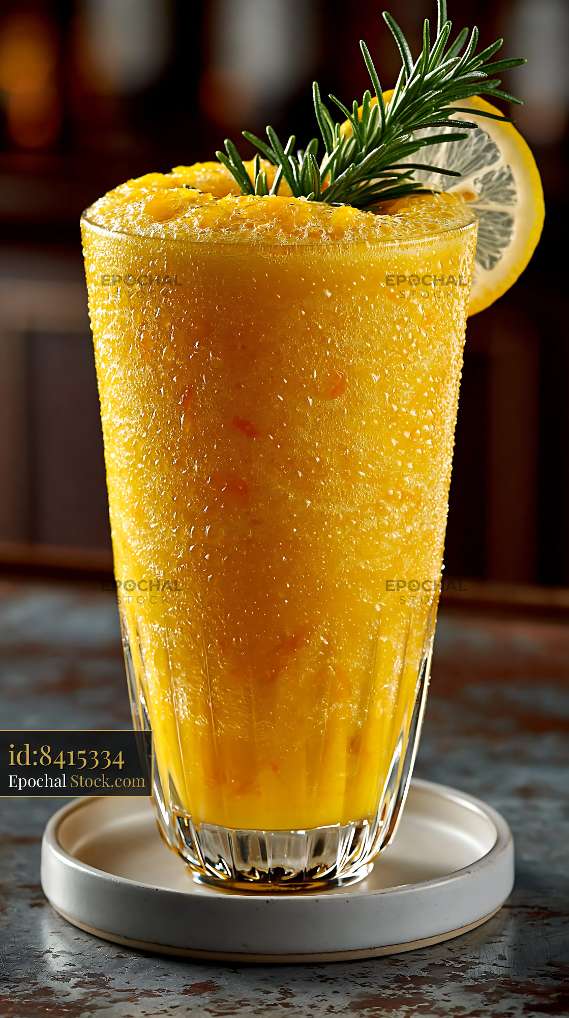 Yuja citron smoothie with rosemary and lemon garnish in a bar - stock photo