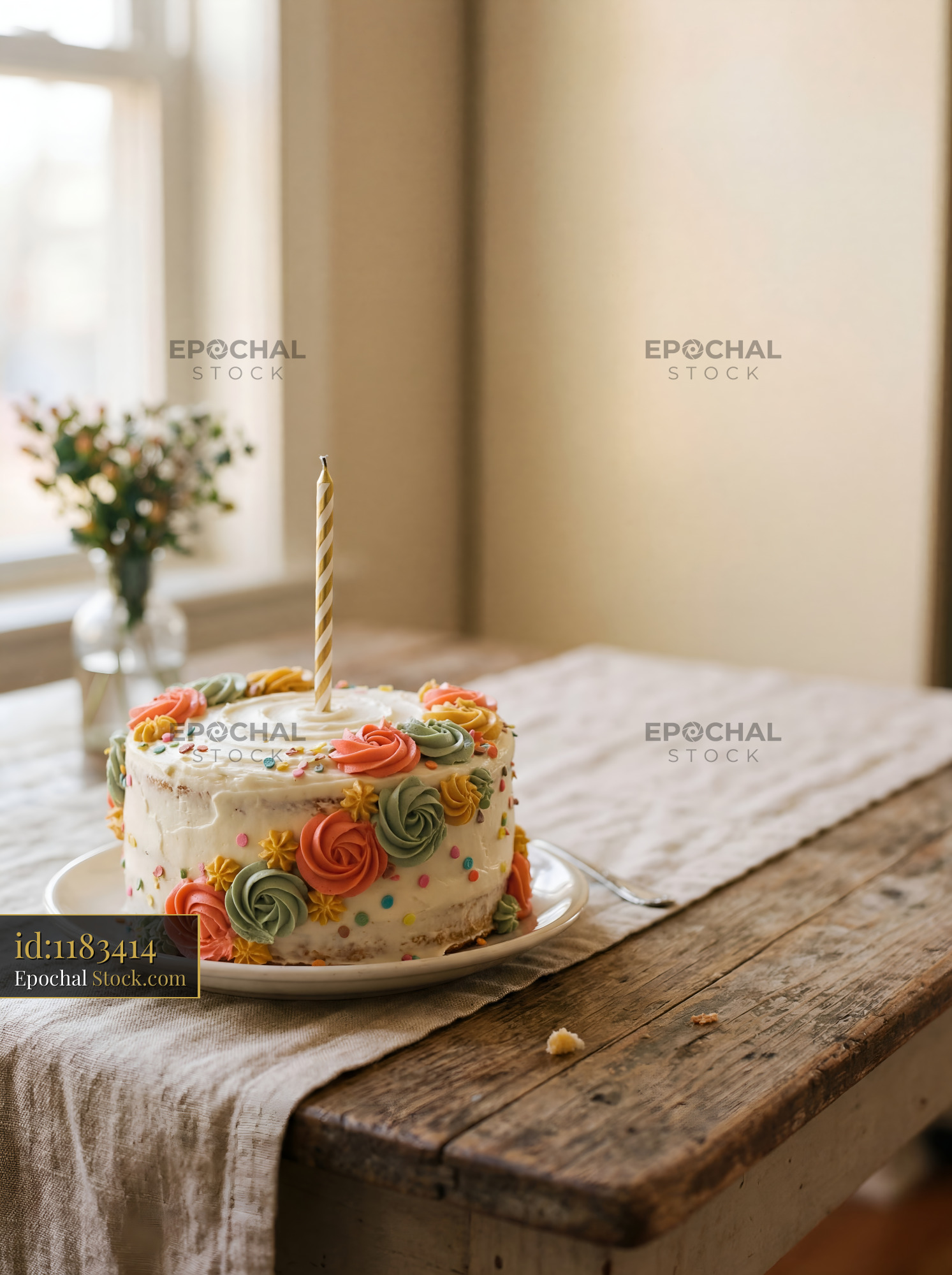 Celebration cake on table with flowers in the background Premium Stock Photo - stock photo