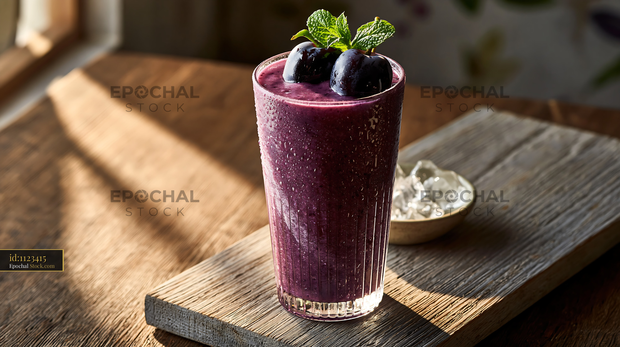 Kyoho grape smoothie topped with fresh fruit in golden morning light - stock photo
