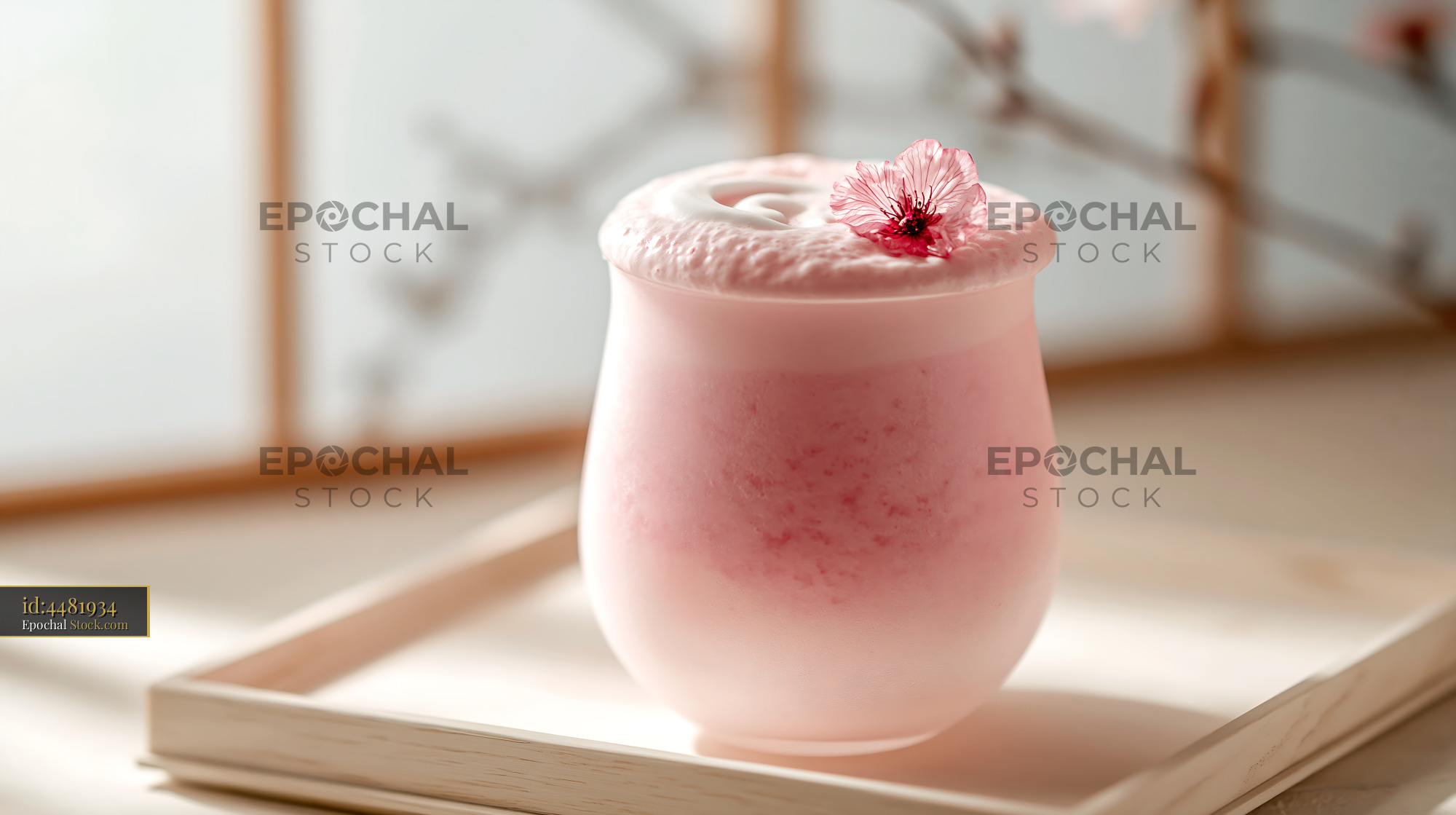 Pink sakura blossom smoothie with foam and flower on wooden tray - stock photo