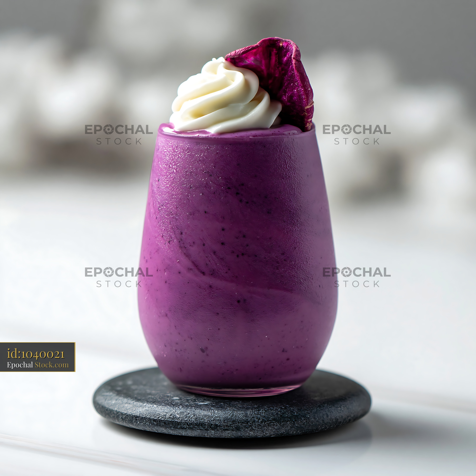 Purple beni imo smoothie with whipped cream on a stone coaster - stock photo