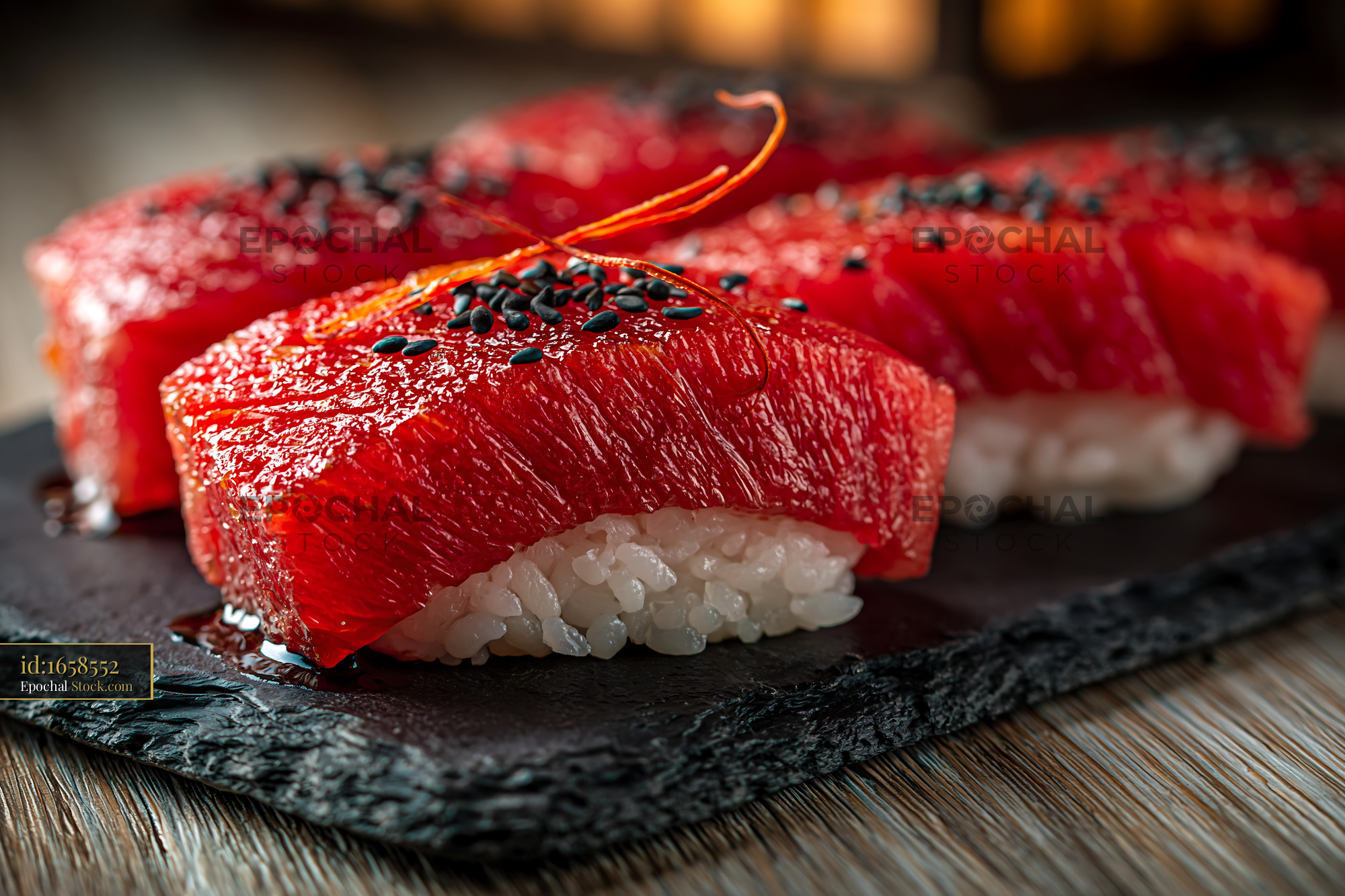 Watermelon tuna sushi nigiri with black sesame on a slate platter - stock photo