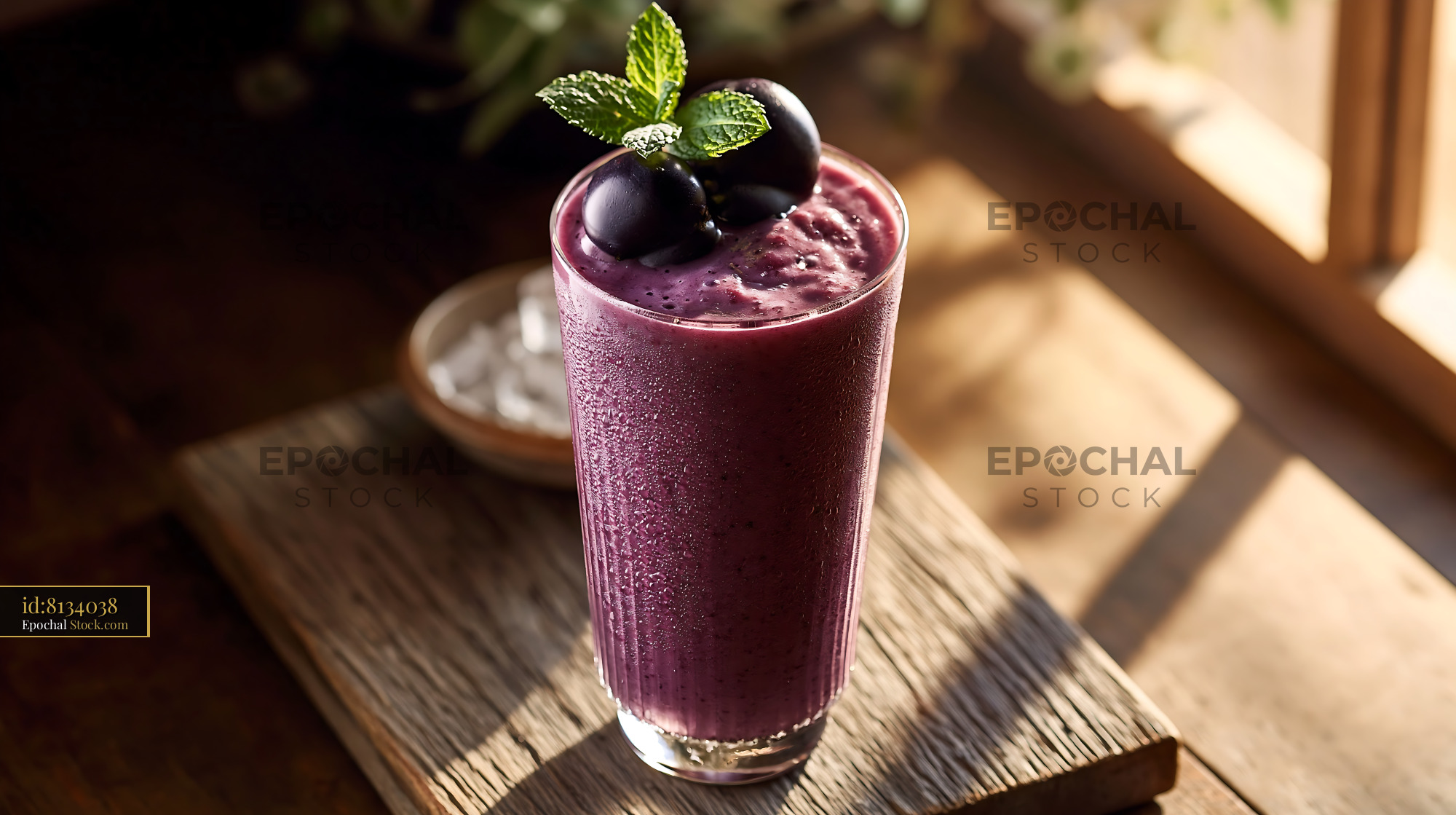 Kyoho grape smoothie with fresh mint garnish in warm sunlight - stock photo