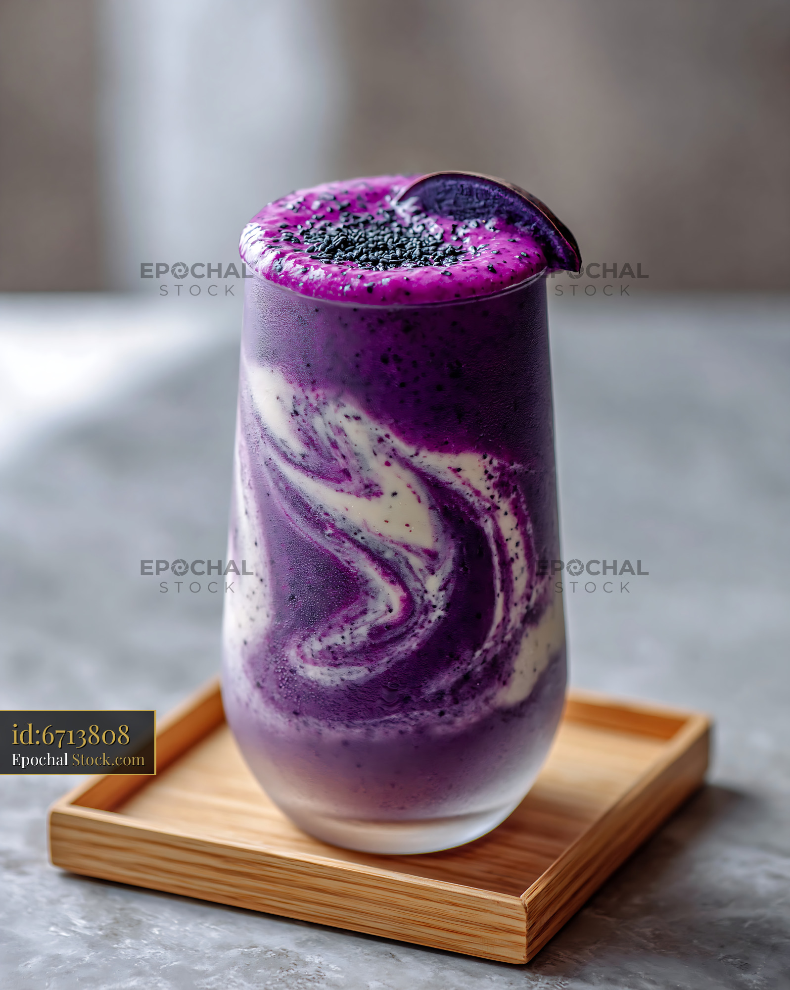 Vibrant purple sweet potato smoothie with yogurt swirl on wooden tray - stock photo