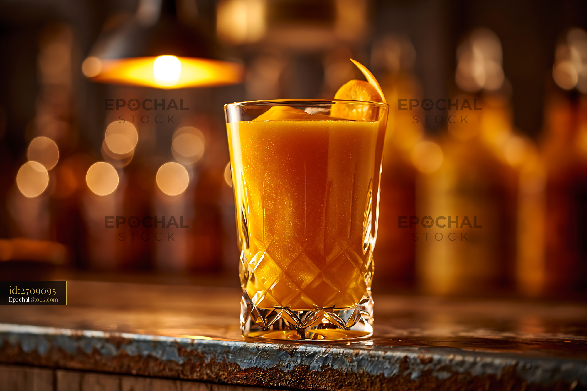 Mikan orange smoothie in a crystal glass on a rustic bar counter - stock photo