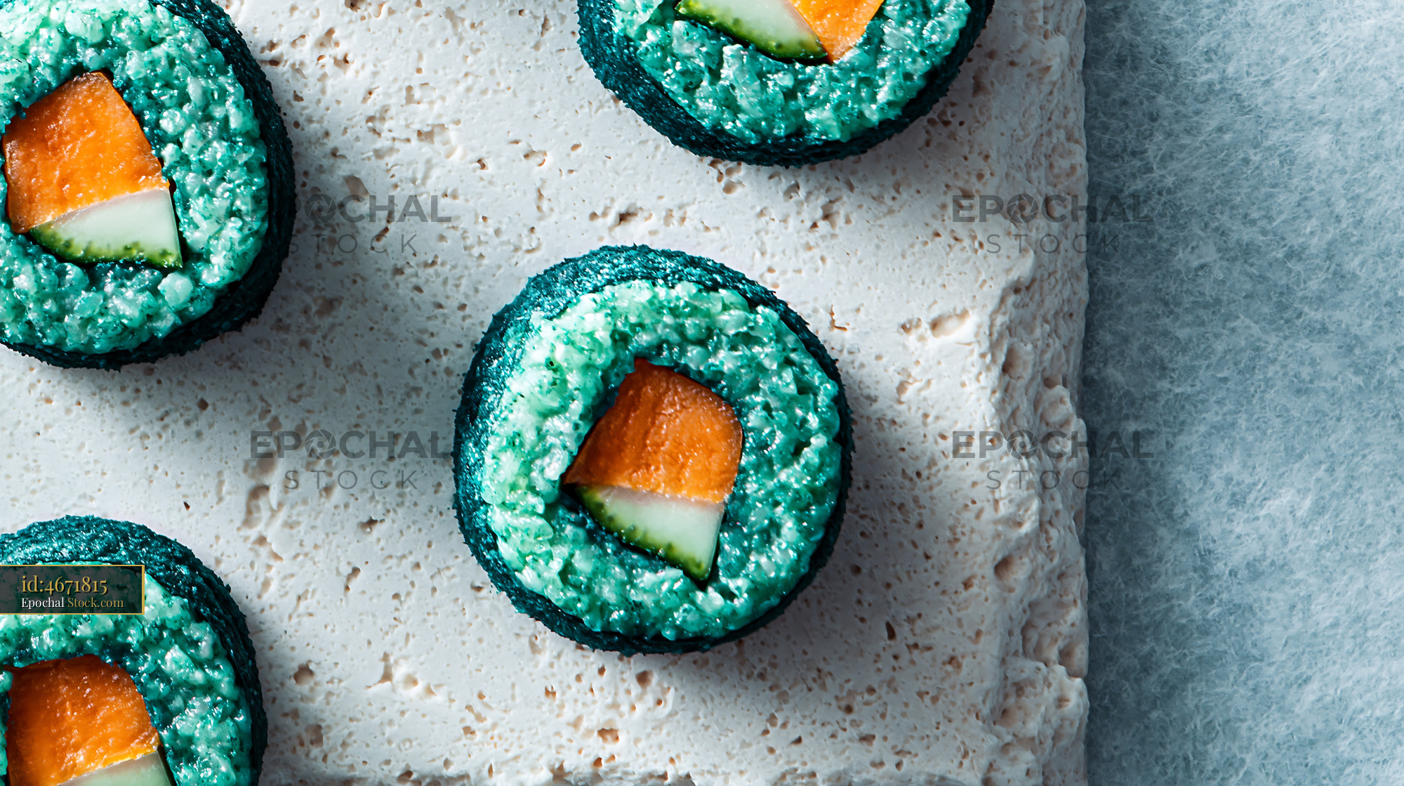 Healthy sushi rolls made with blue spirulina powder and salmon - stock photo