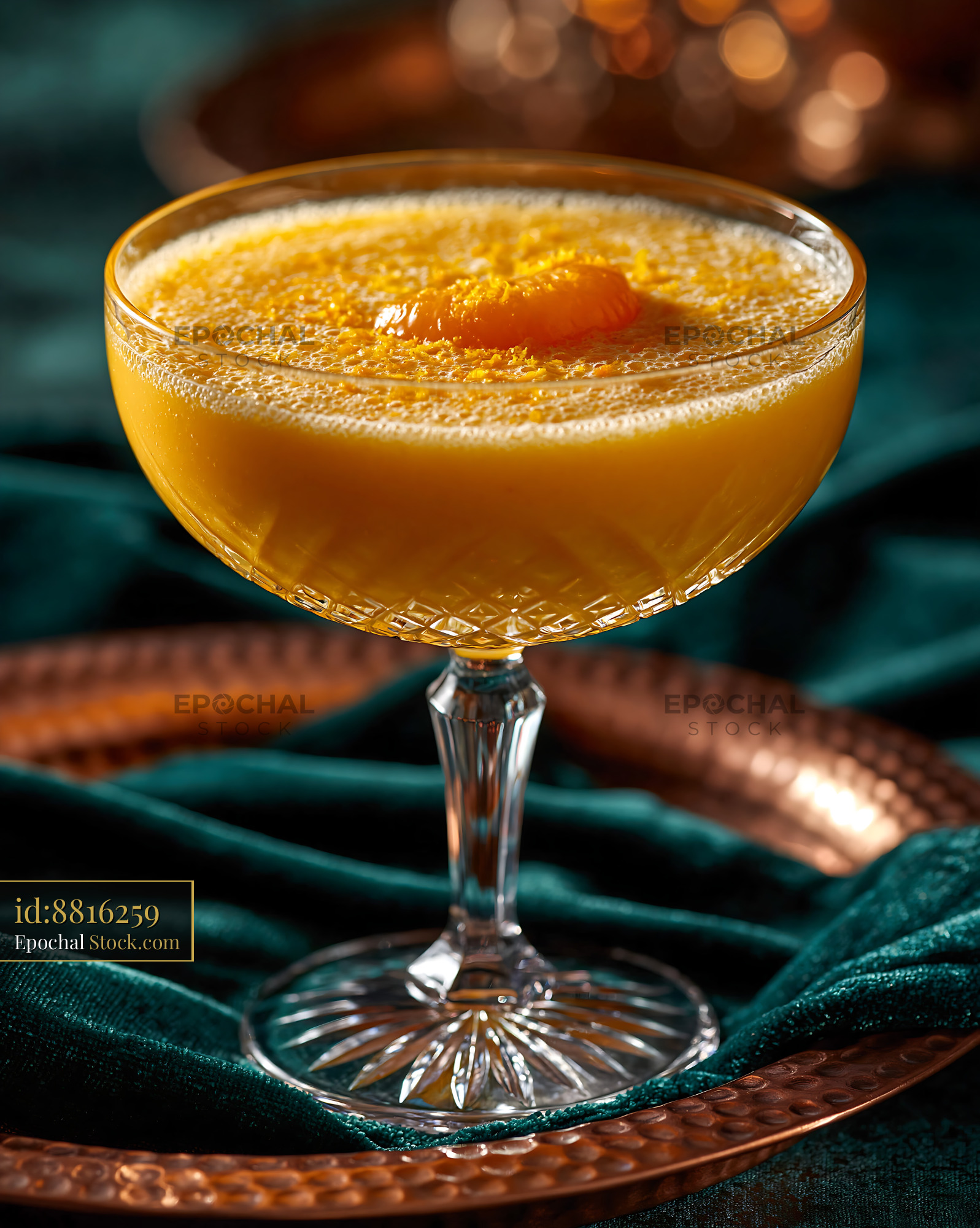 Mikan orange smoothie in a crystal coupe glass on green velvet - stock photo