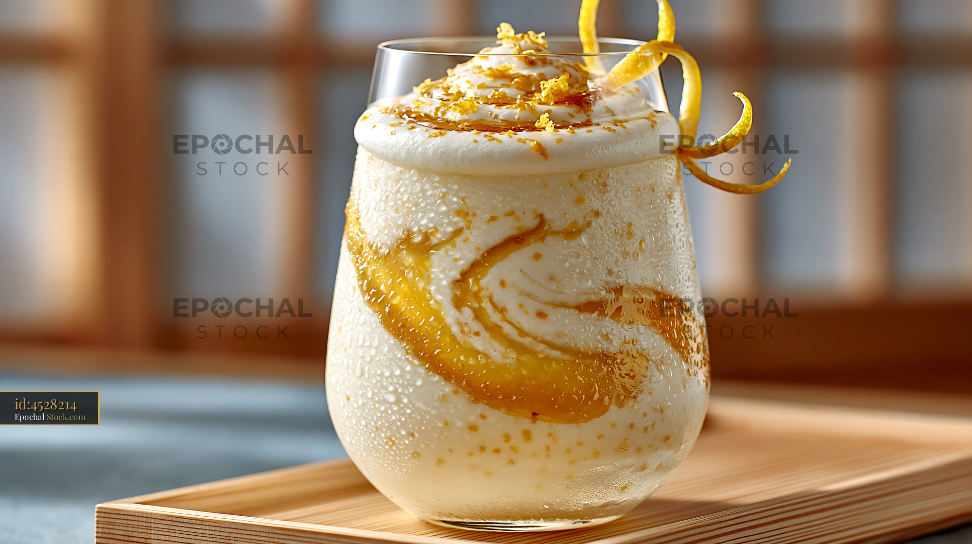 Yuzu honey smoothie with frothy foam and citrus zest on a wooden tray - stock photo