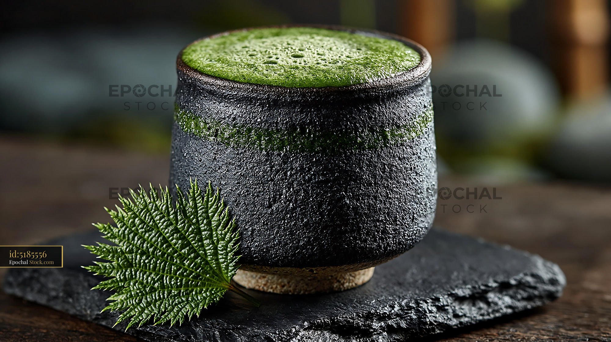 Mugwort herb smoothie in a rustic ceramic cup with a fresh green leaf - stock photo