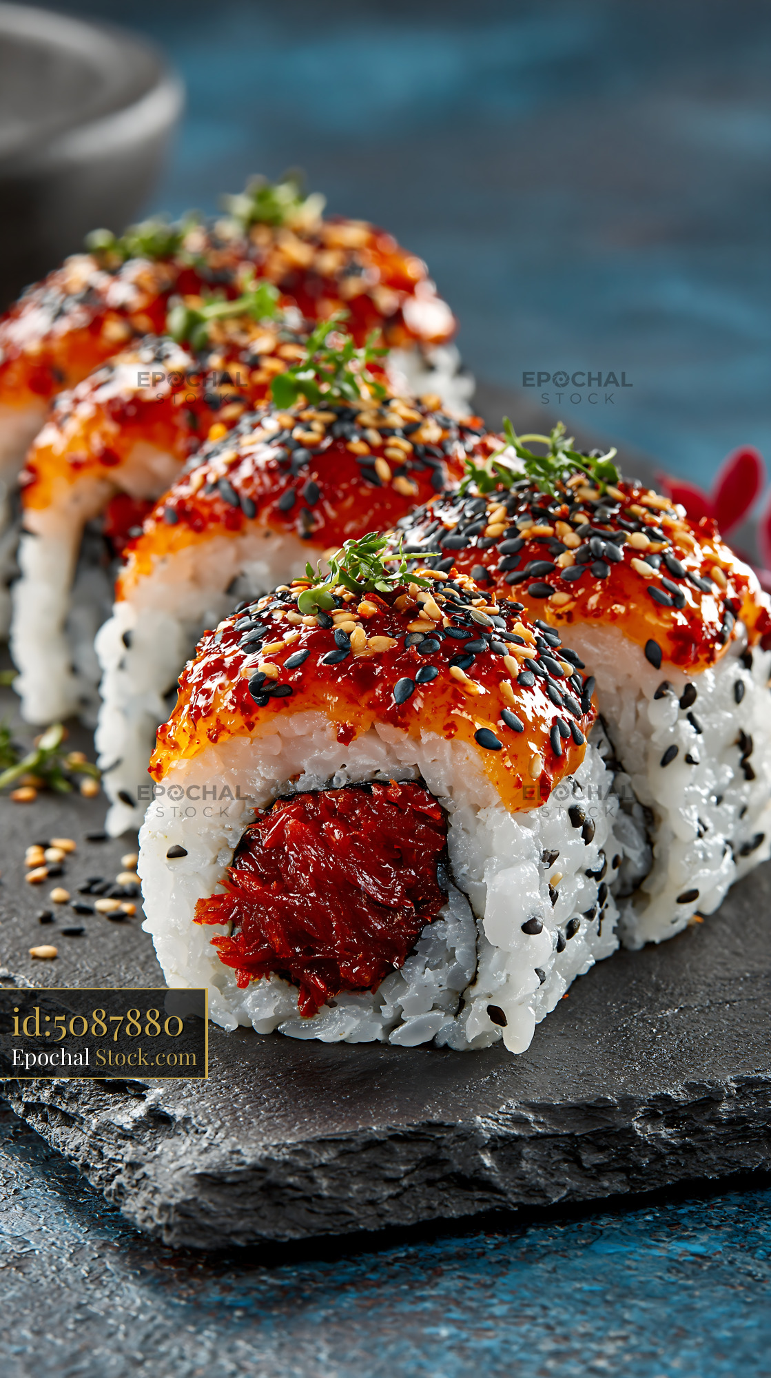 Kimchi fusion maki sushi rolls with sesame seeds on slate board - stock photo