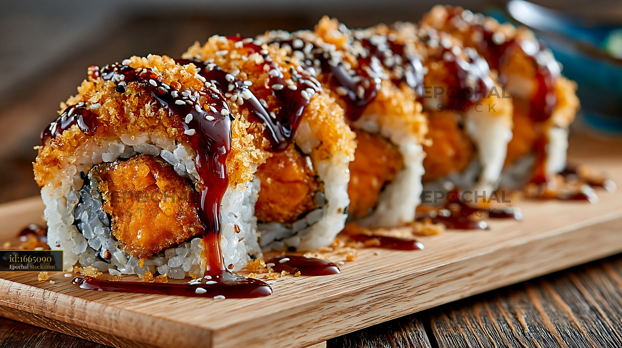 Sweet potato crunch sushi rolls with teriyaki sauce on wooden board - stock photo