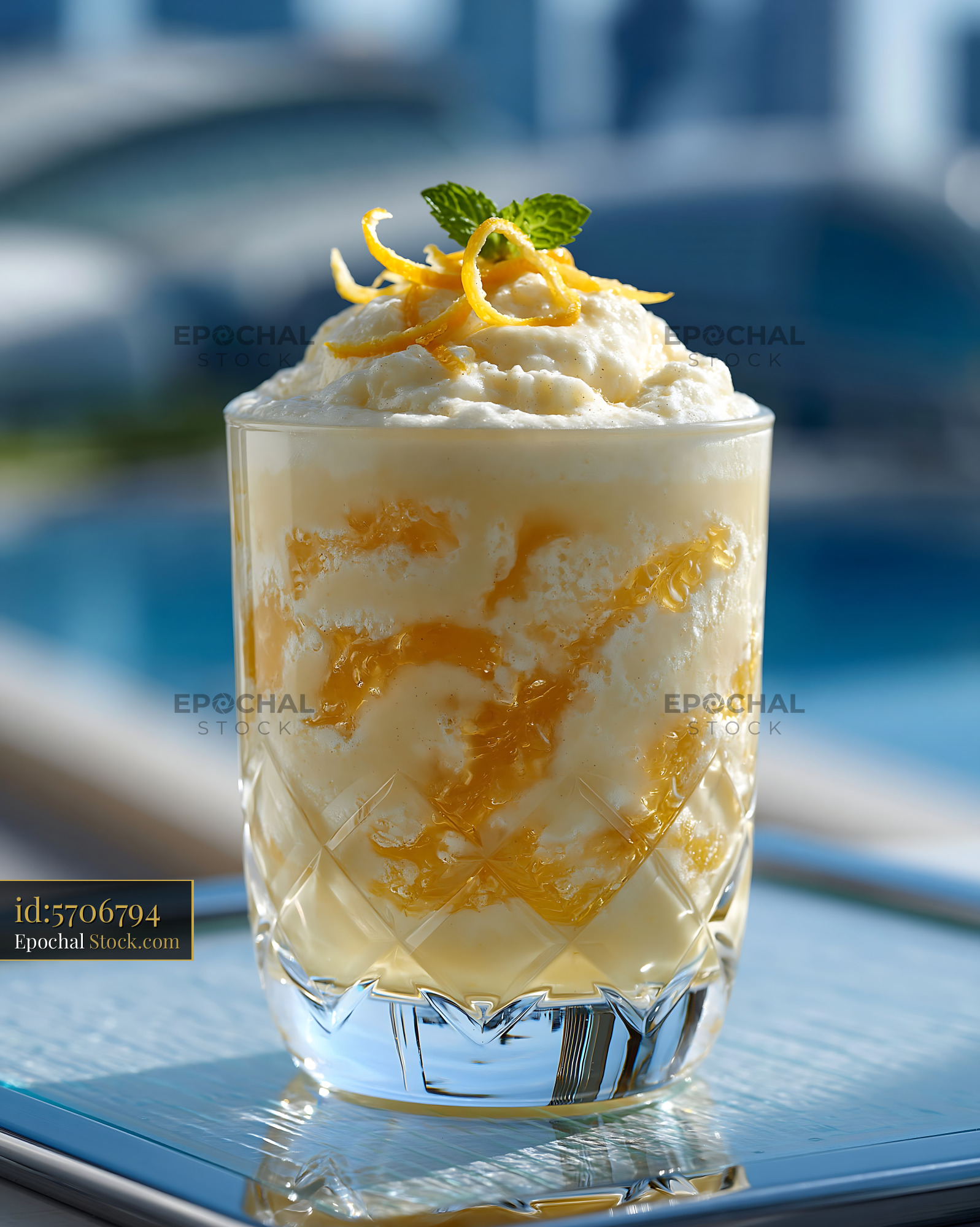Refreshing yuzu honey smoothie with citrus zest by a swimming pool - stock photo