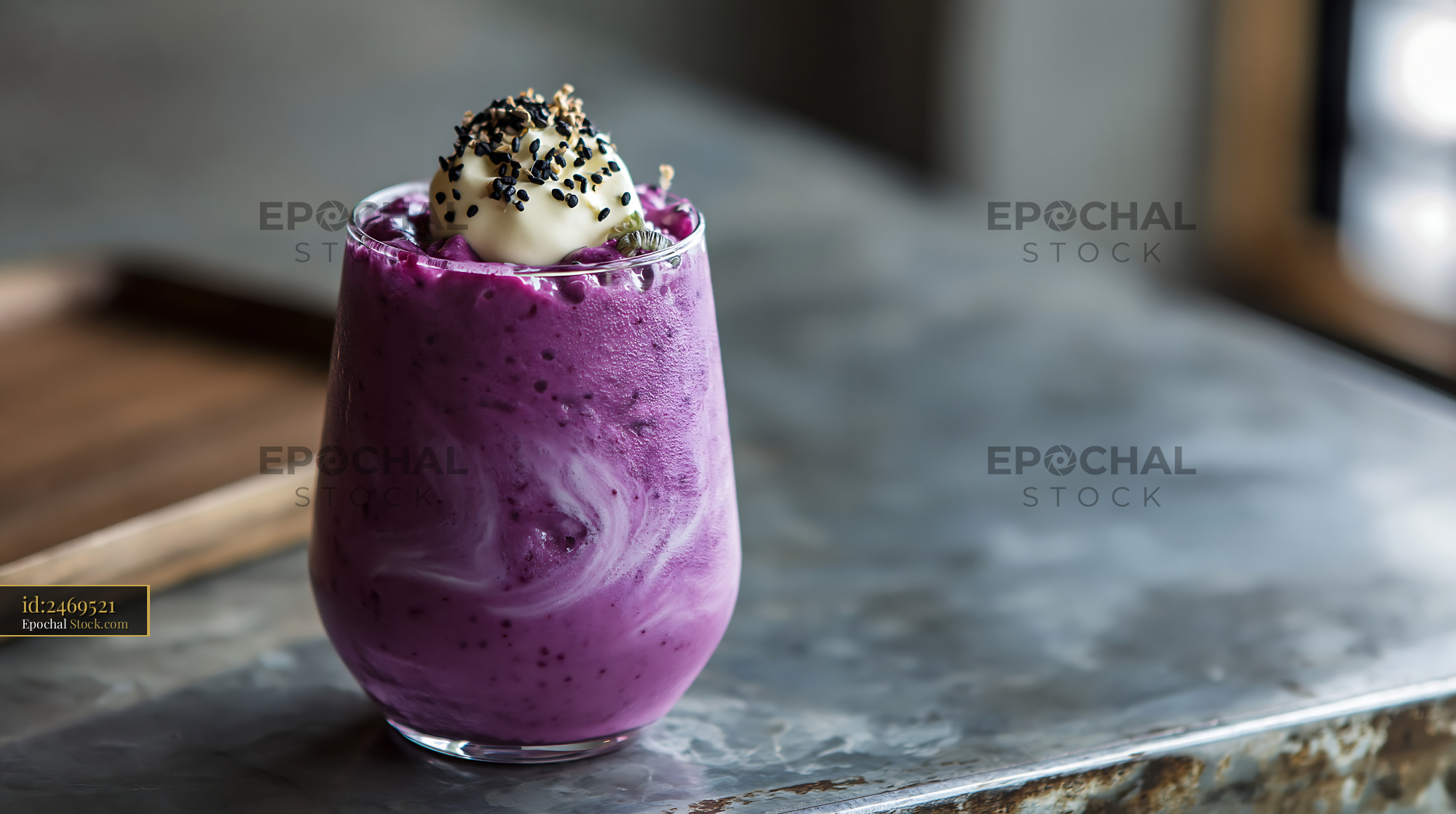 Vibrant beni imo smoothie with cream and black sesame on a rustic tabl - stock photo