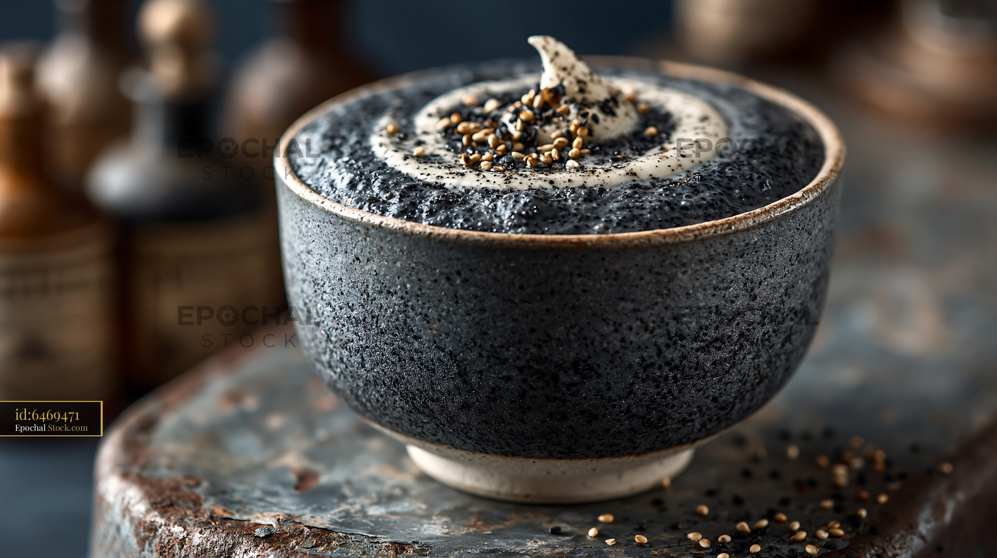Black sesame kurogoma smoothie in a rustic bowl with cream - stock photo