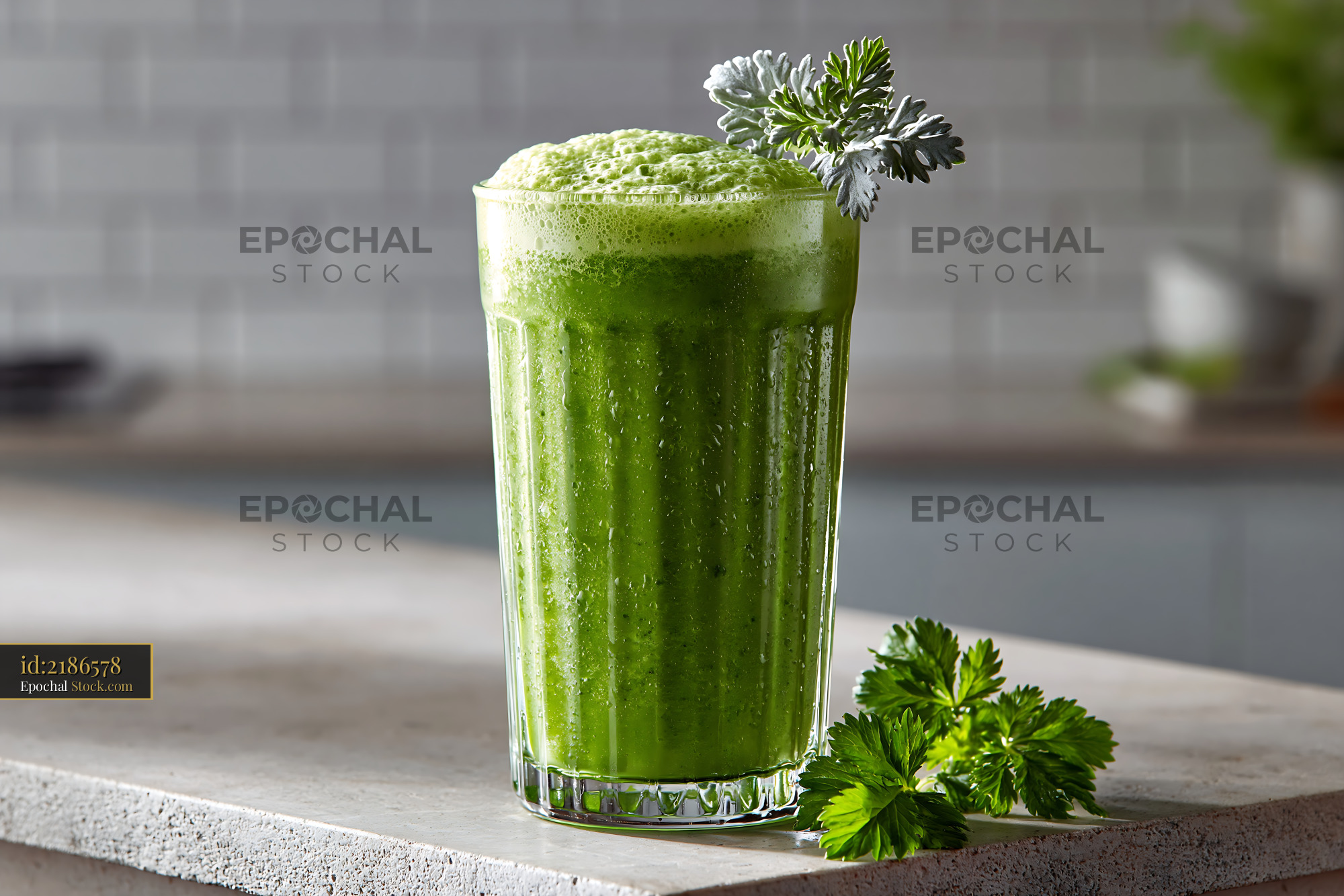 Mugwort herb smoothie with foam in a tall glass on a kitchen counter - stock photo