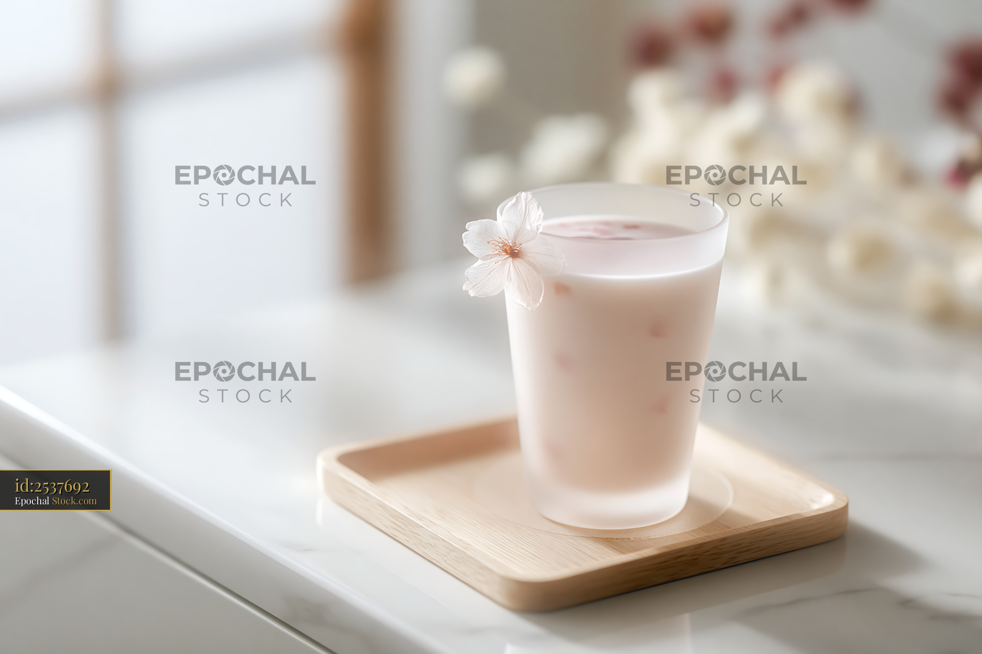 Sakura blossom smoothie in a frosted glass on a wooden tray - stock photo