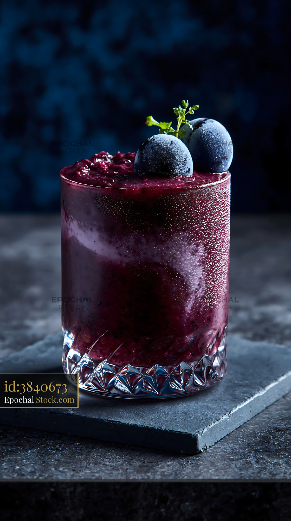 Refreshing purple Kyoho grape smoothie topped with frozen fruit - stock photo