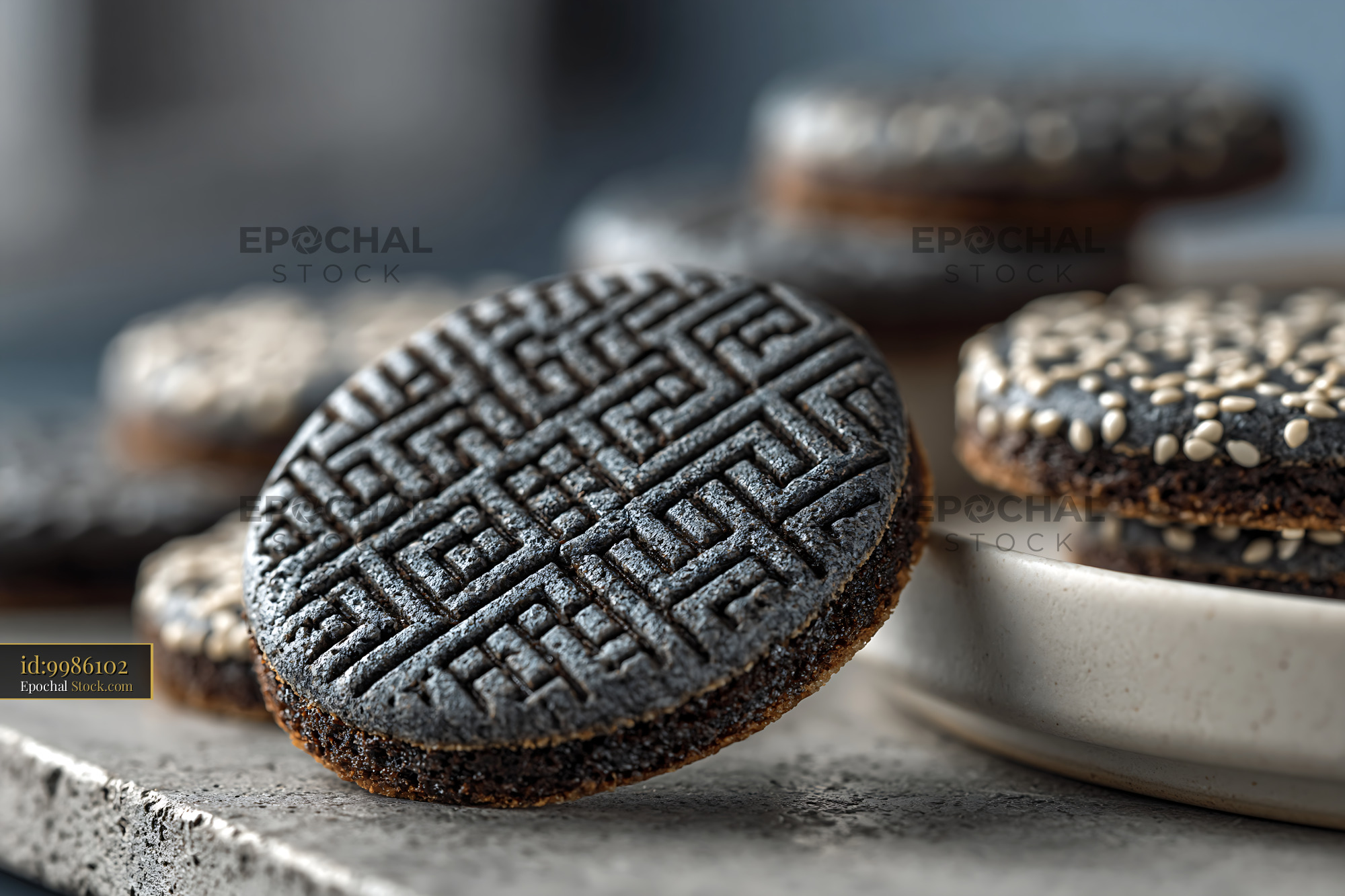 Artisanal dibs el kharroub biscuits with carob molasses on stone table - stock photo