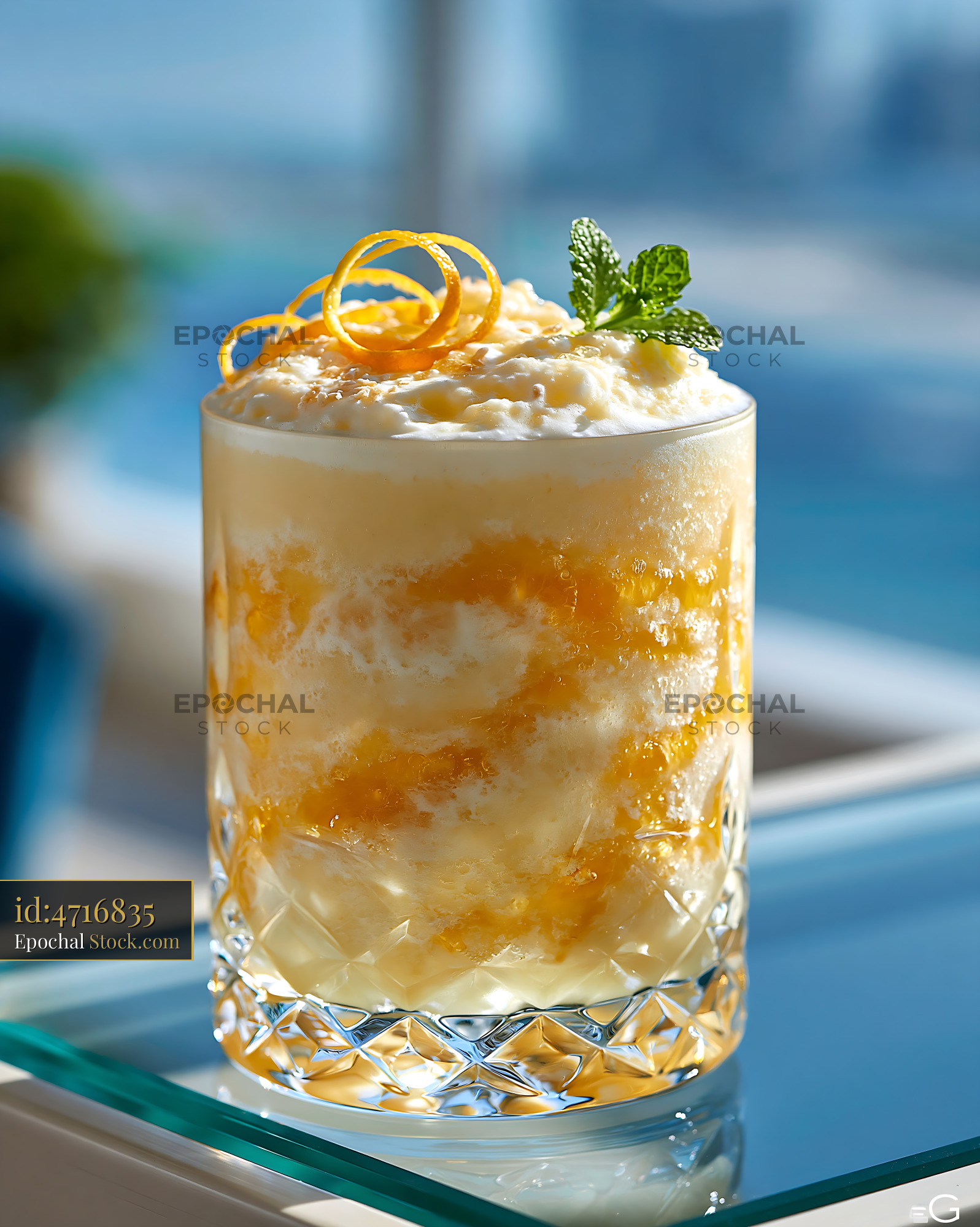 Yuzu honey smoothie with orange zest and mint in a crystal glass - stock photo