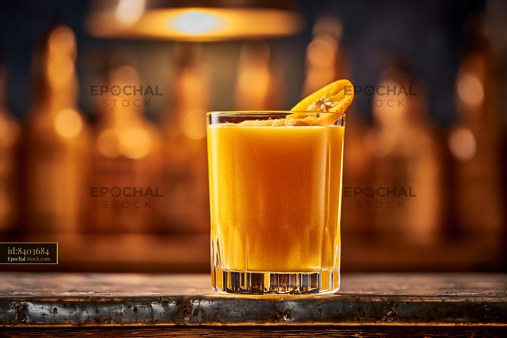 Mikan orange smoothie with citrus garnish on a rustic bar counter - stock photo