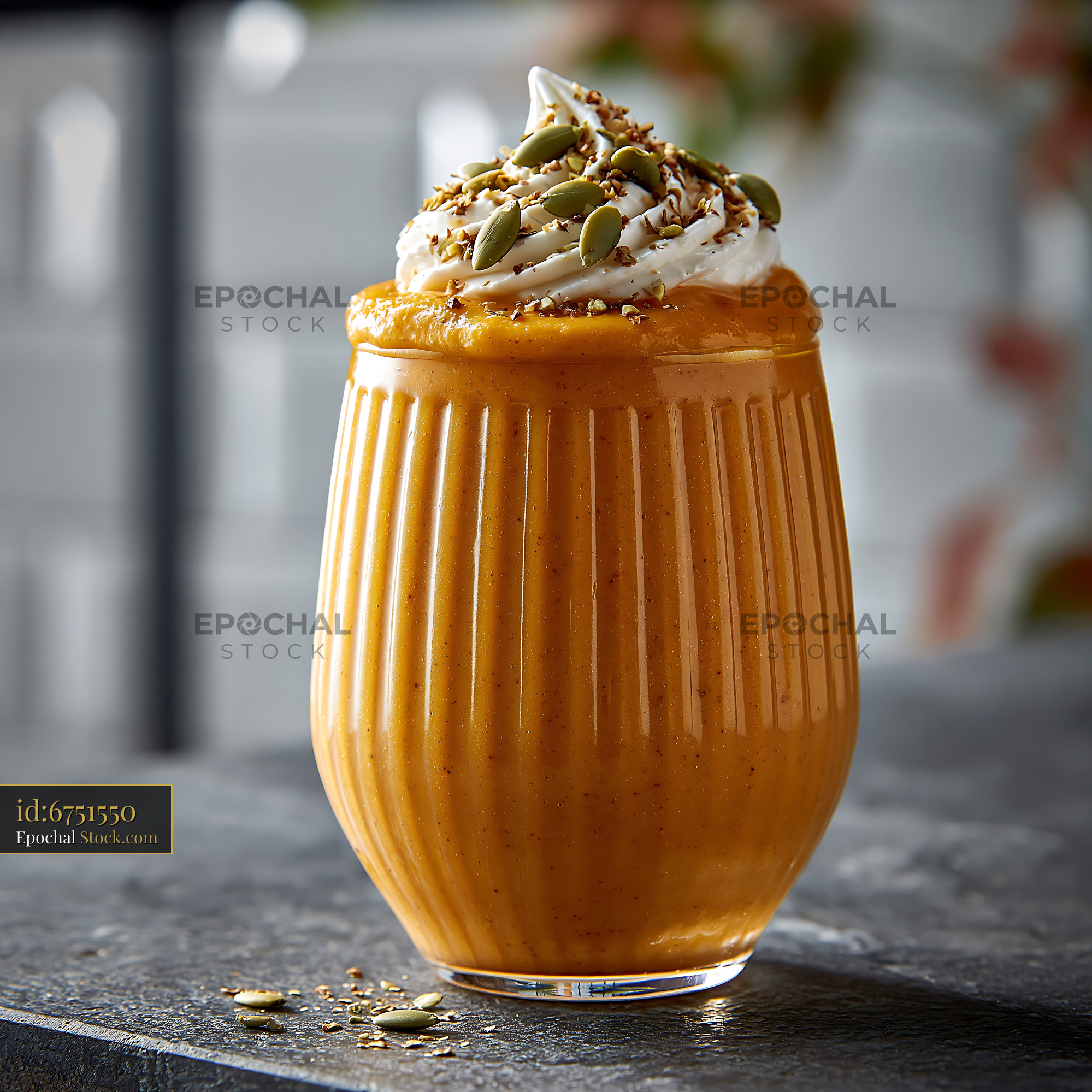 Creamy kabocha pumpkin smoothie with whipped cream and seeds - stock photo