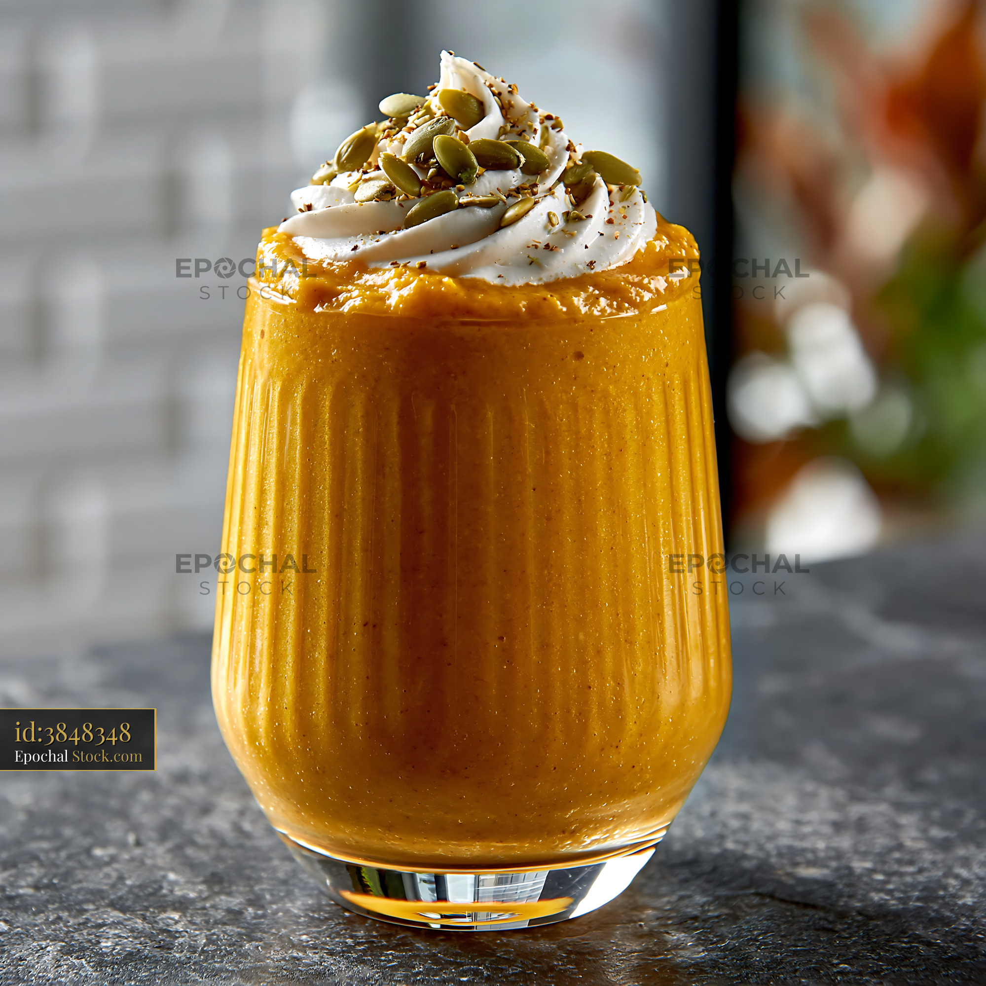 Creamy kabocha pumpkin smoothie topped with whipped cream and seeds - stock photo