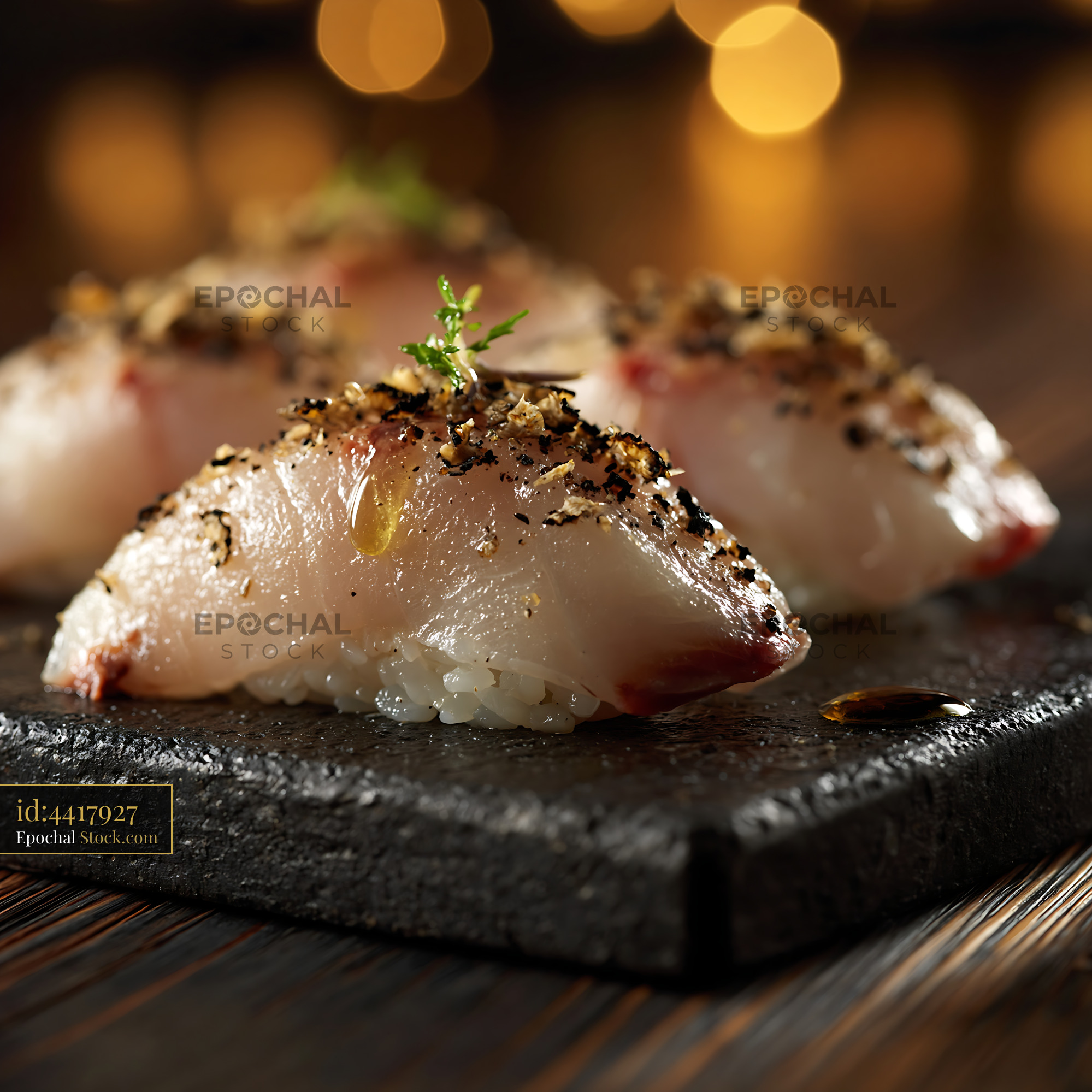 Gourmet truffle yellowtail sushi nigiri on a dark stone plate - stock photo