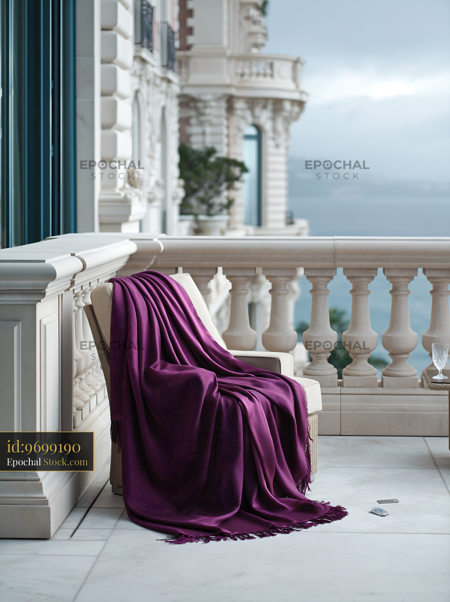 Purple throw blanket on lounge chair at luxury hotel balcony view - stock photo
