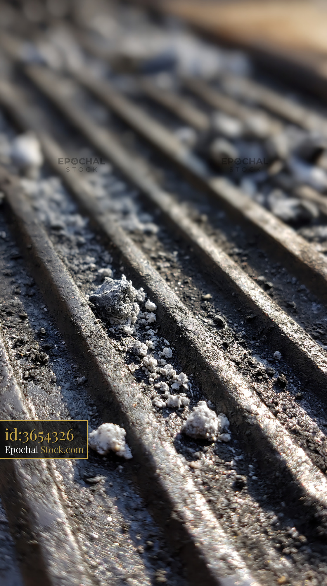 Close up of dirty barbecue grill grate with ash after a garden party - stock photo