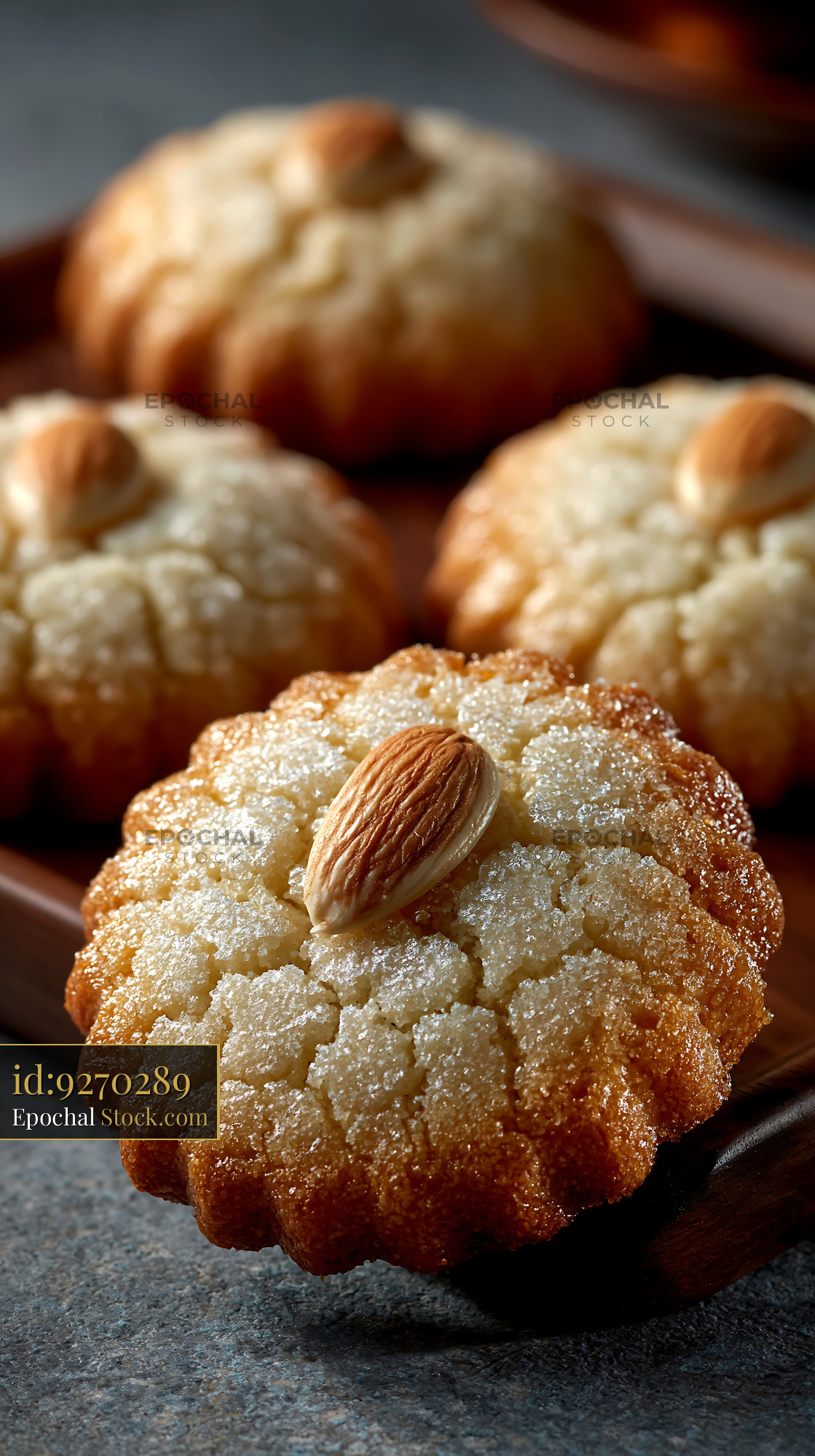 Traditional dibs el kharroub biscuits with almonds on a wooden tray - stock photo