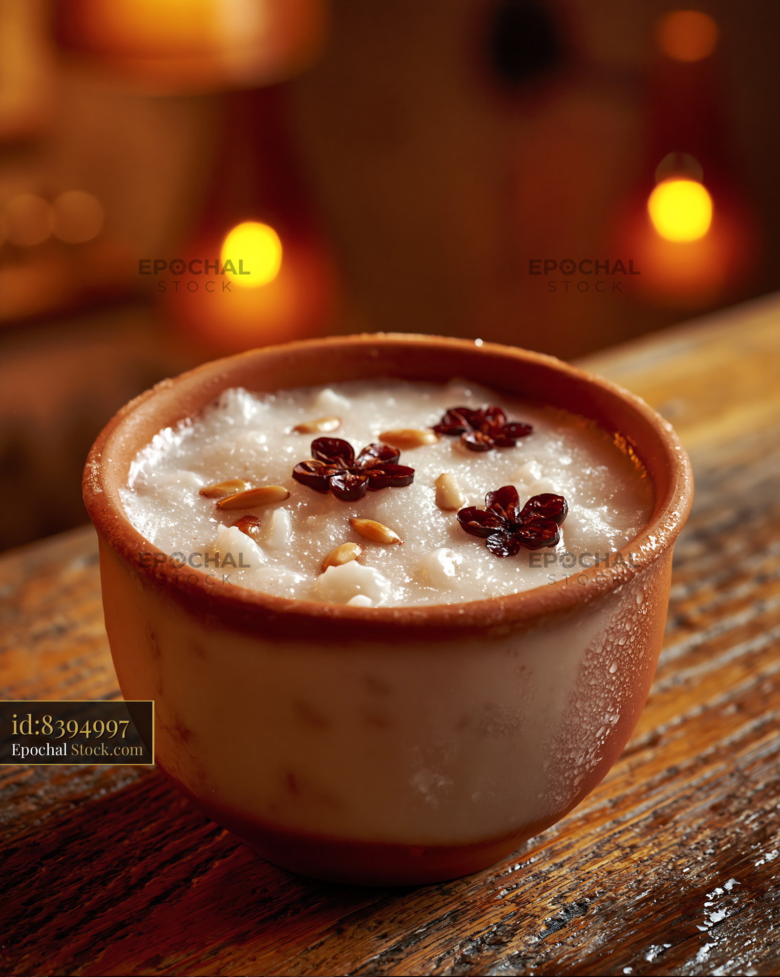 Traditional sikhye rice smoothie in clay bowl on wooden table - stock photo