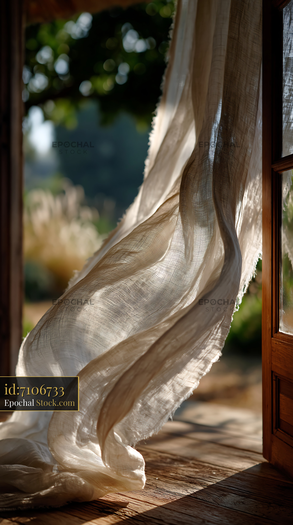White linen curtains blowing in the breeze through an open wooden door - stock photo