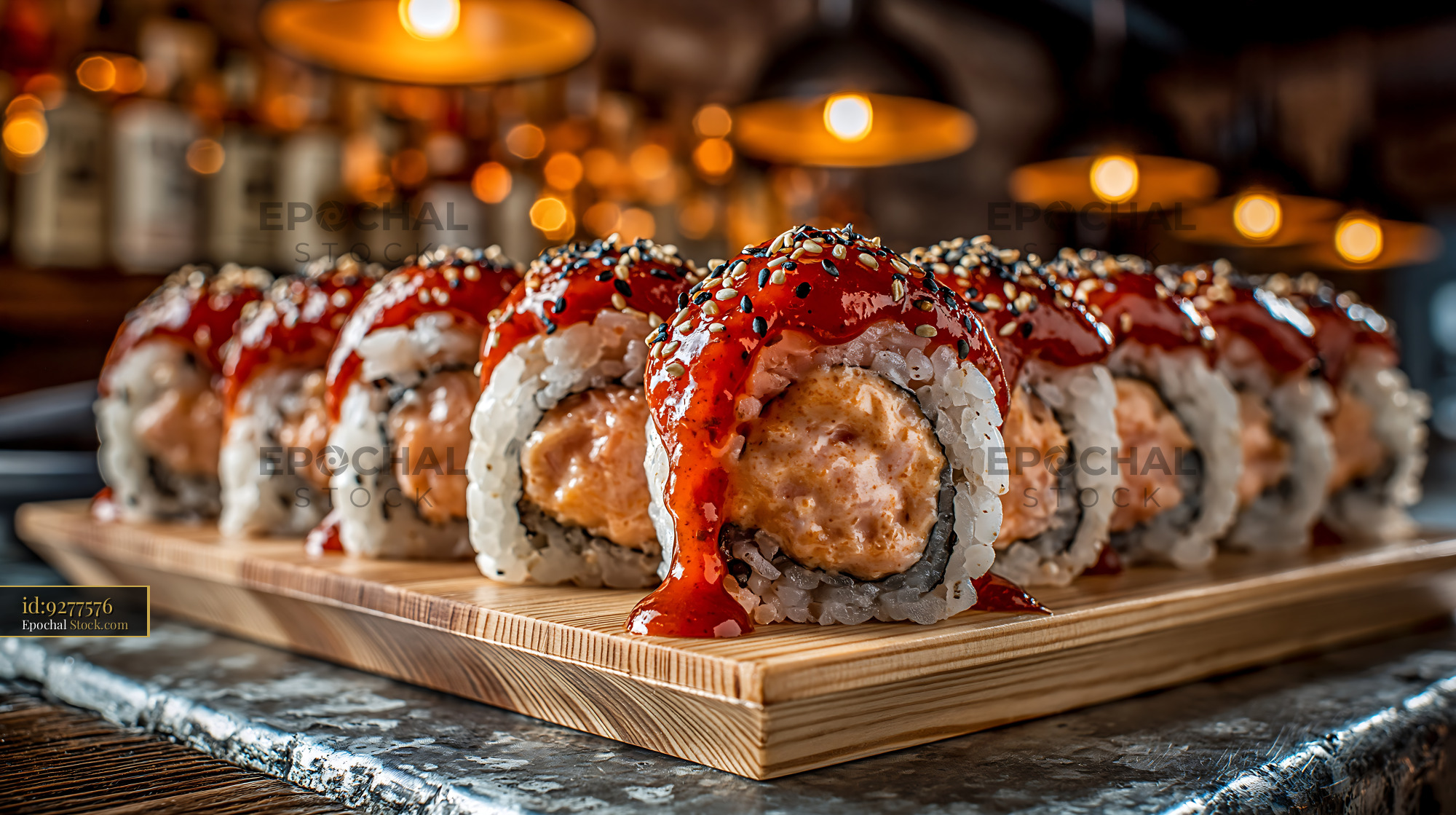 Sriracha mayo tuna sushi rolls served on a wooden board - stock photo
