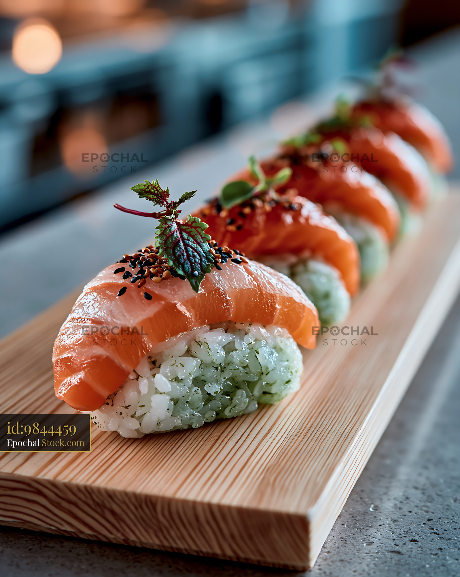 Fresh salmon nigiri with matcha infused rice on a wooden board - stock photo
