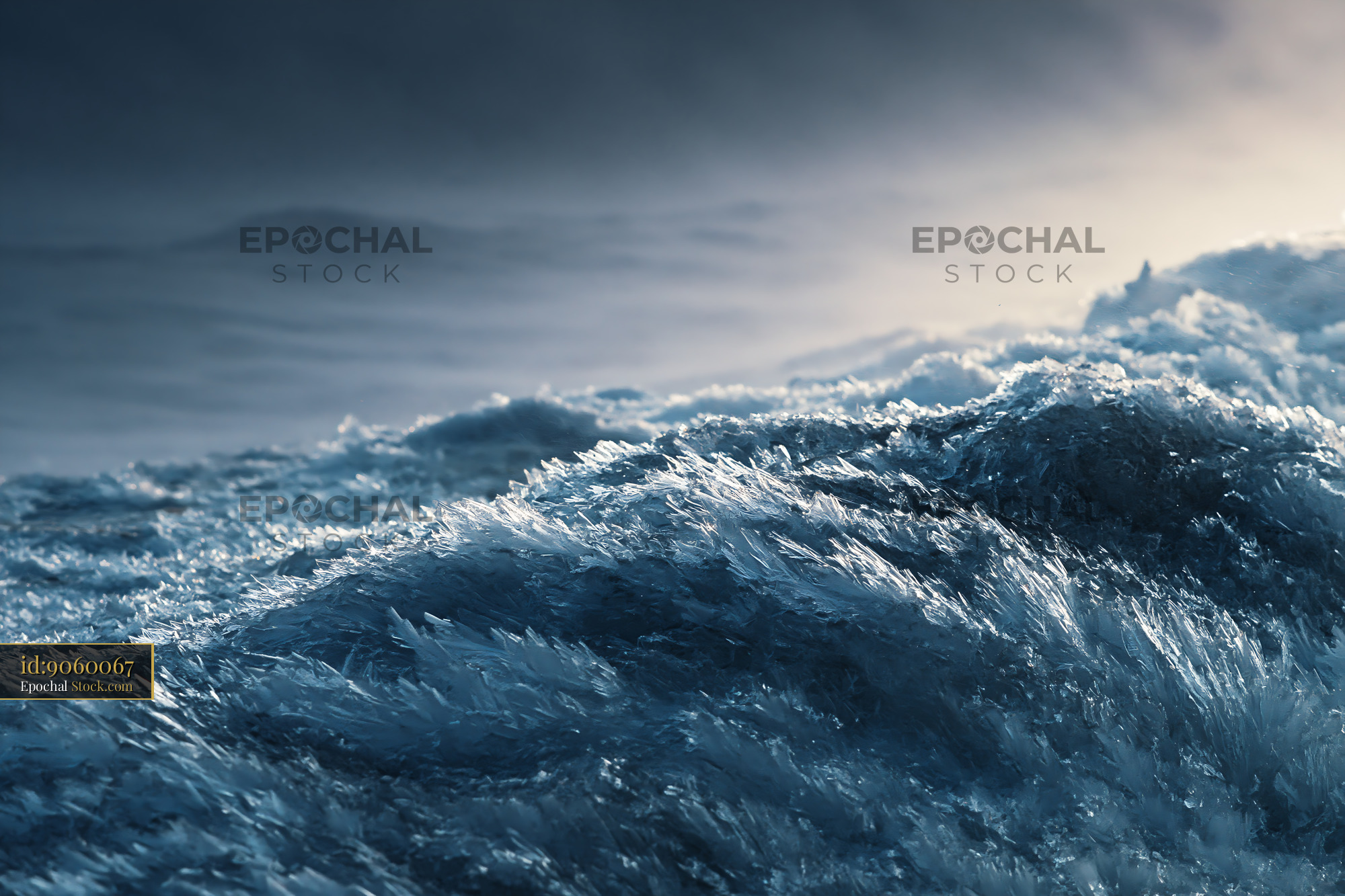 Ice crystals on frozen surface resembling a stormy sea at winter dusk - stock photo