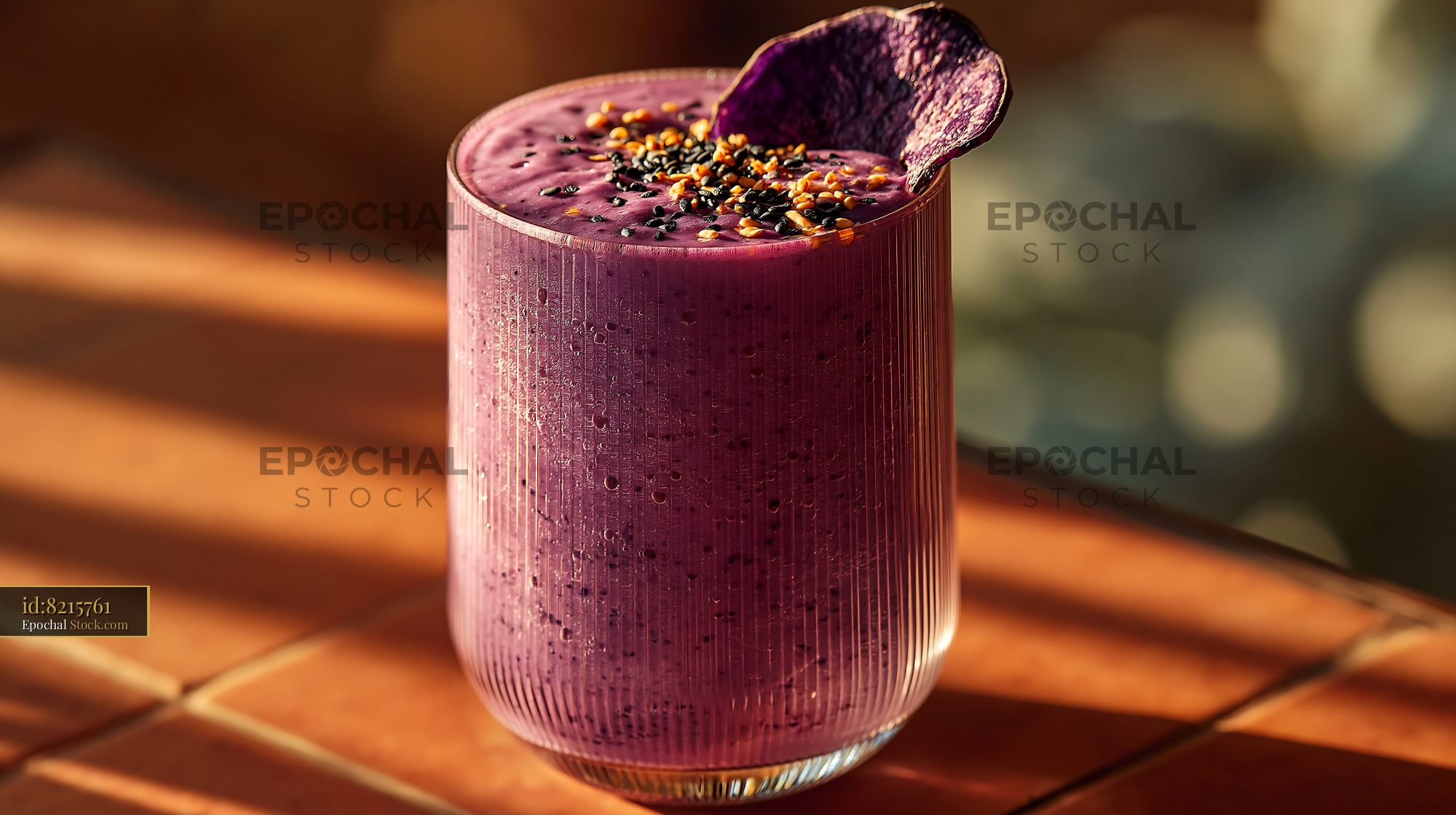 Purple sweet potato smoothie topped with sesame seeds in warm sunlight - stock photo
