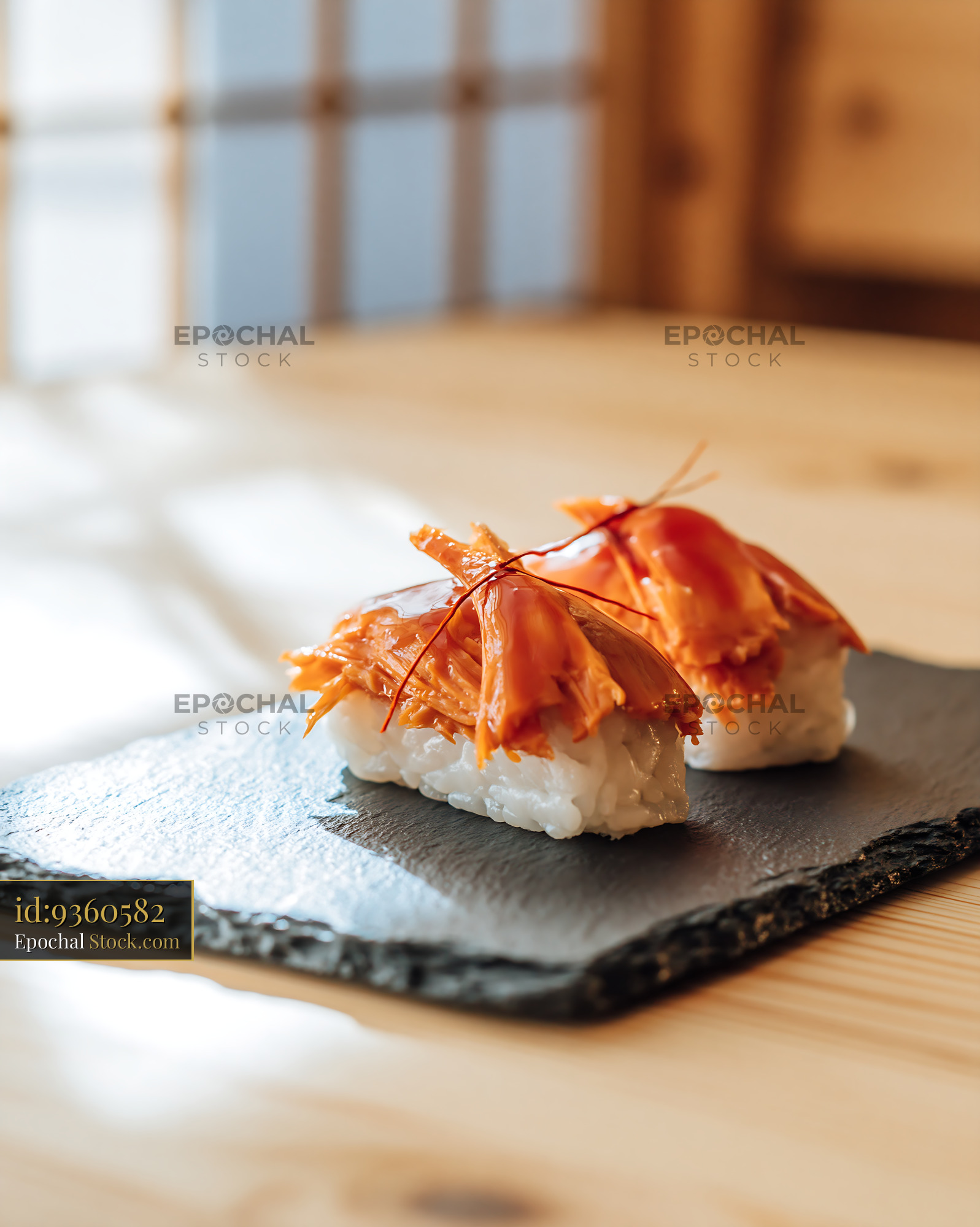 Two pieces of vegan jackfruit nigiri sushi on a black slate plate - stock photo