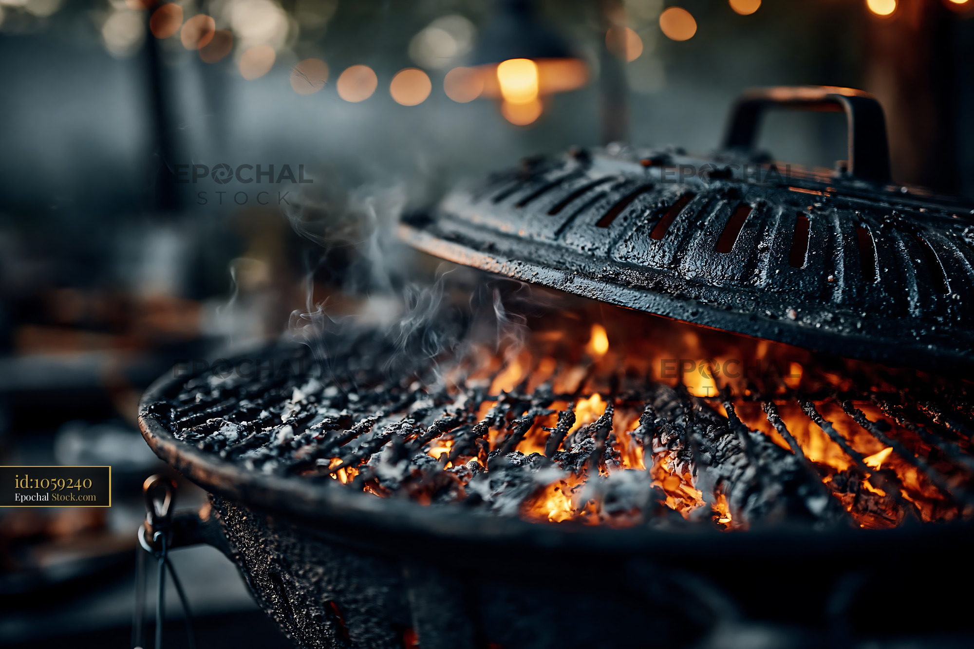Barbecue grill with glowing charcoal and smoke at a garden party - stock photo