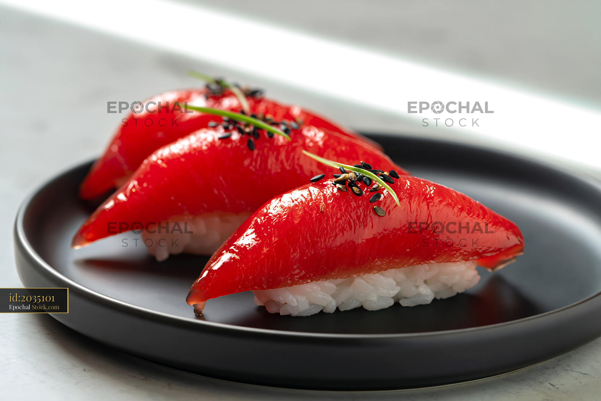 Vegan jackfruit nigiri sushi with black sesame seeds on a black plate - stock photo